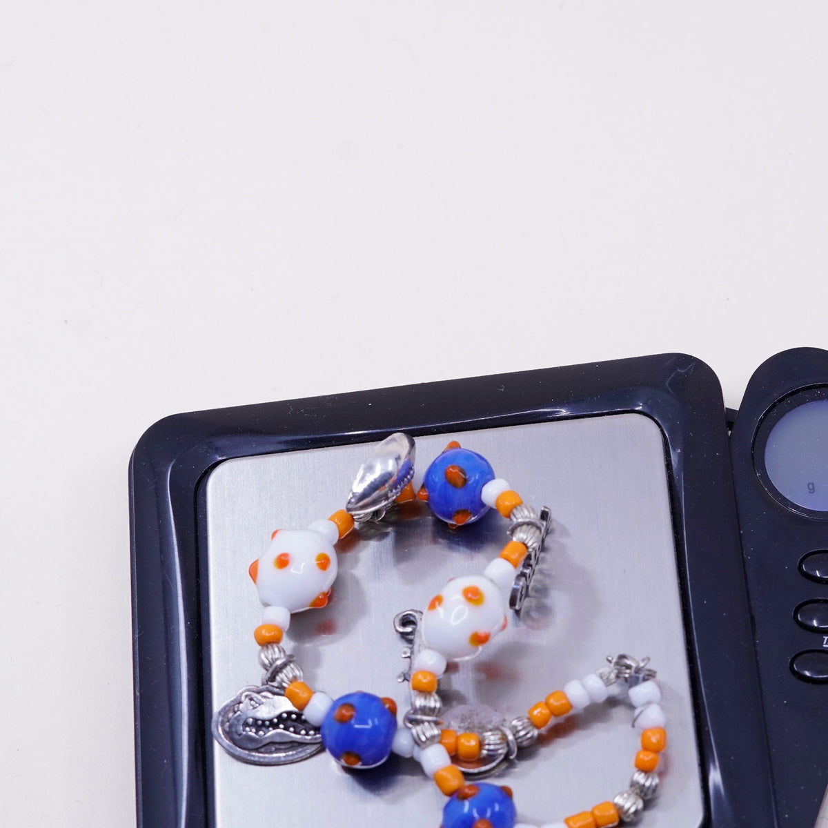 7.75”, blue and orange glass beads w/ sterling 925 silver alligator football