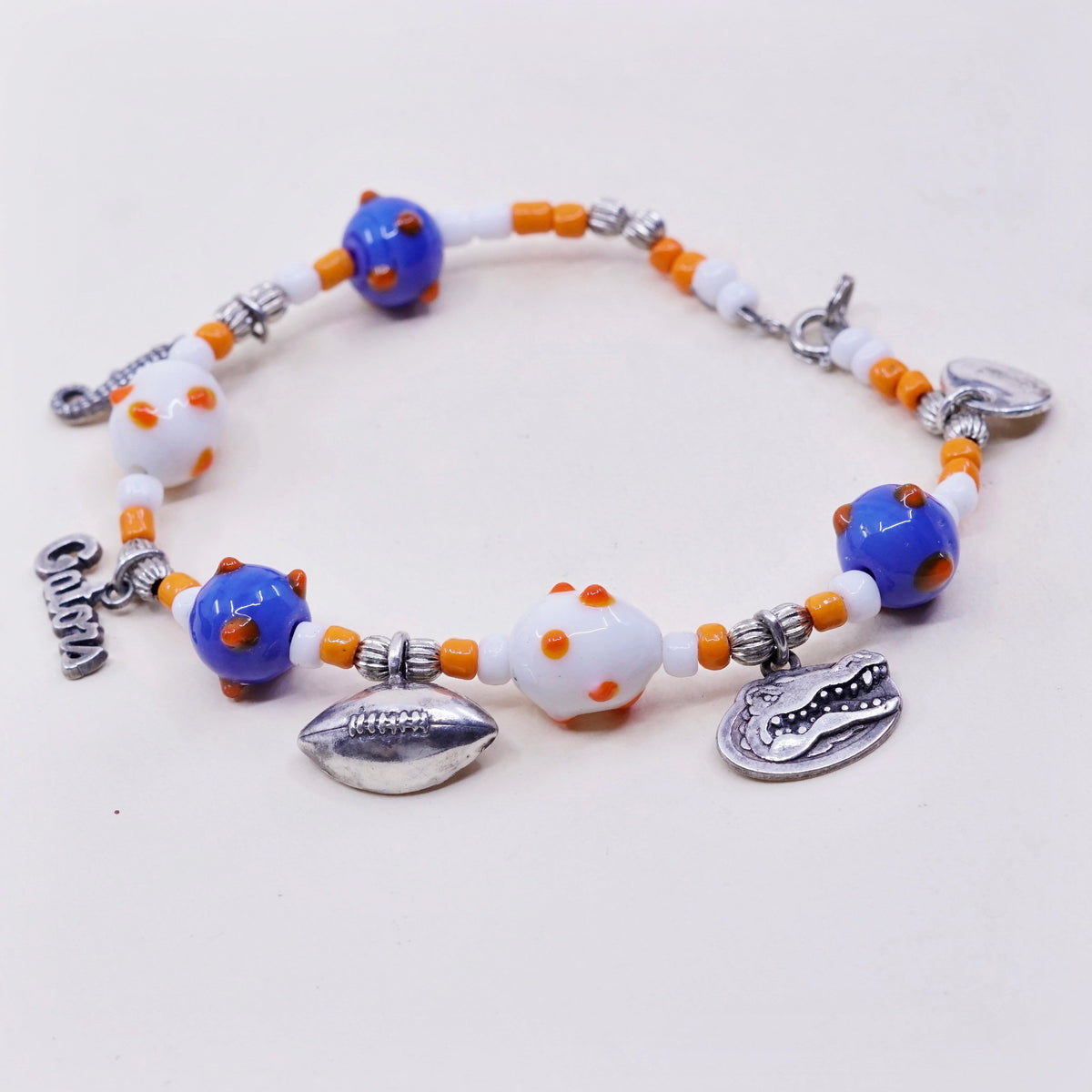 7.75”, blue and orange glass beads w/ sterling 925 silver alligator football