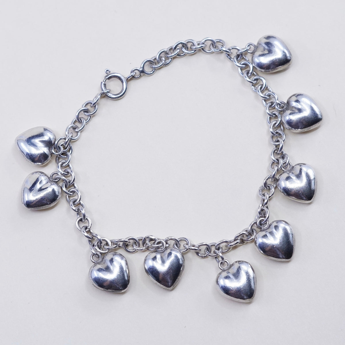 7.75”, 3mm, vtg JCM sterling 925 silver circle bracelet w/ cluster heart charms