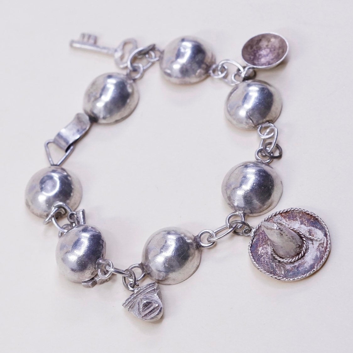 6”, sterling silver Handmade circle bracelet w/ hammer pot hat key sombrero