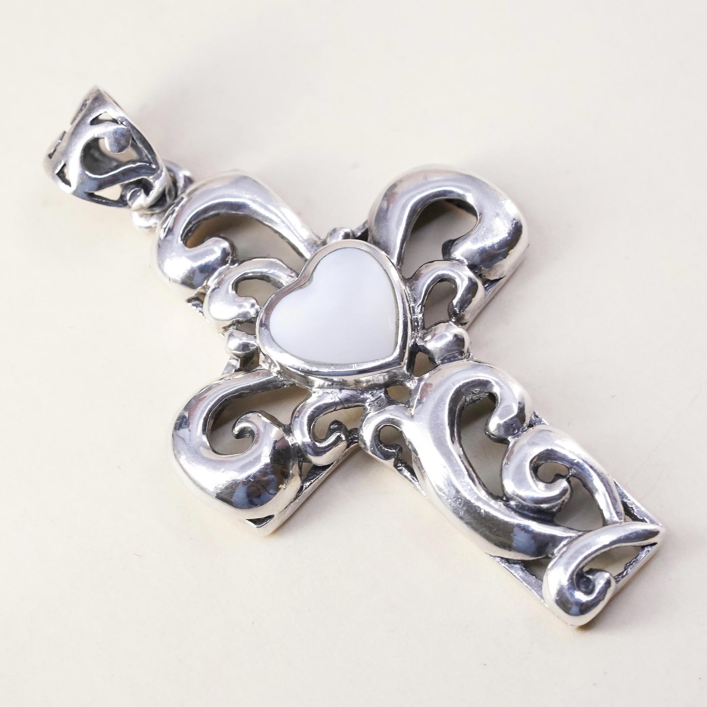 southwestern sterling silver pendant, swirly 925 cross heart mother of pearl