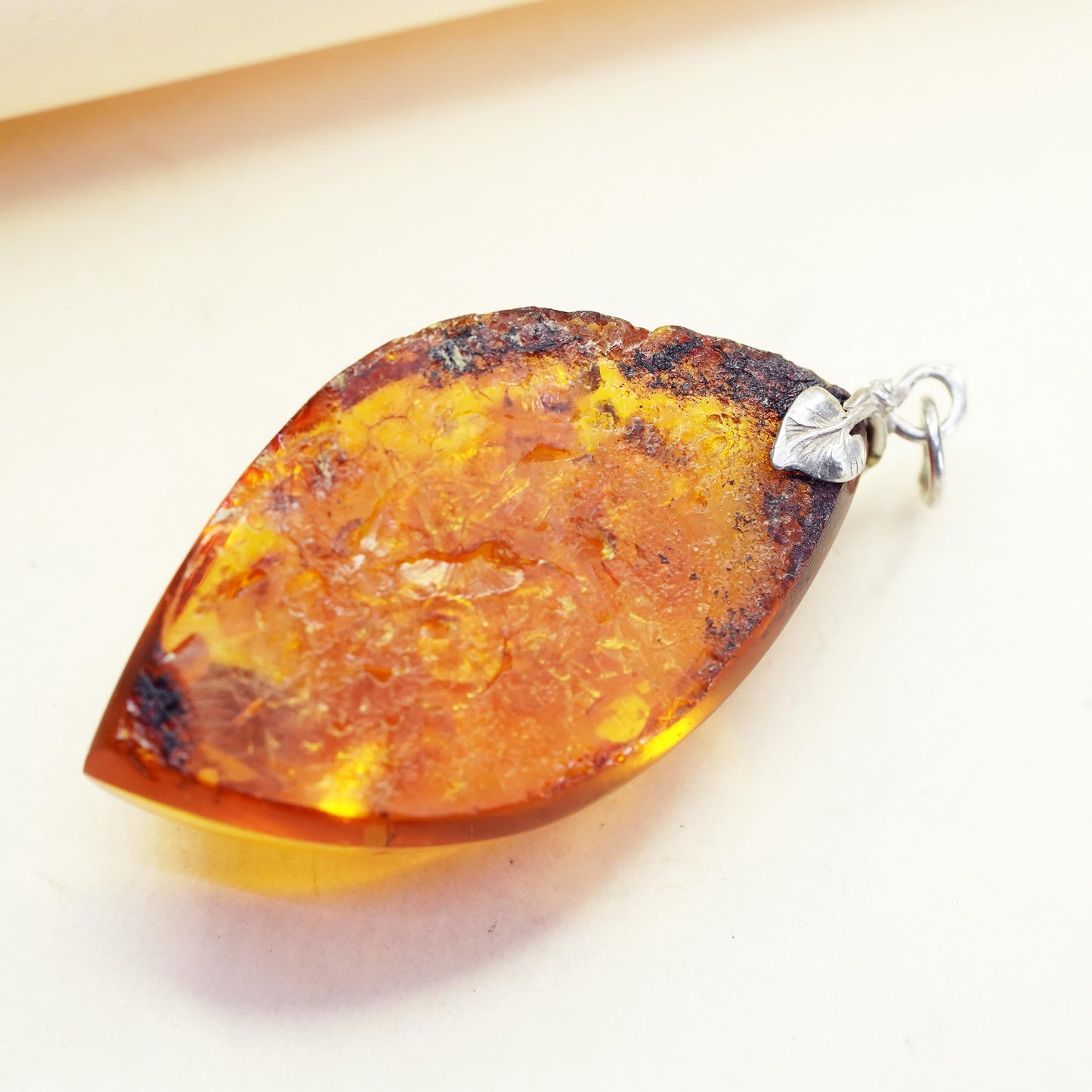 Vintage sterling 925 silver handmade pendant with amber nugget and leaf bail