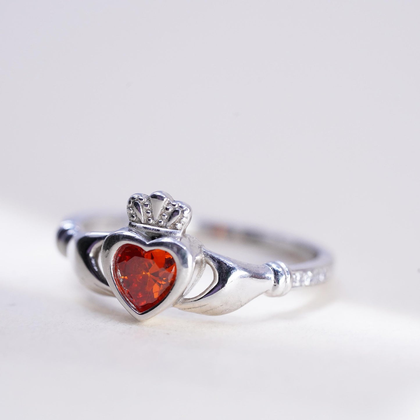 Size 8, Irish sterling 925 silver claddagh ring, holding heart, orange crystal
