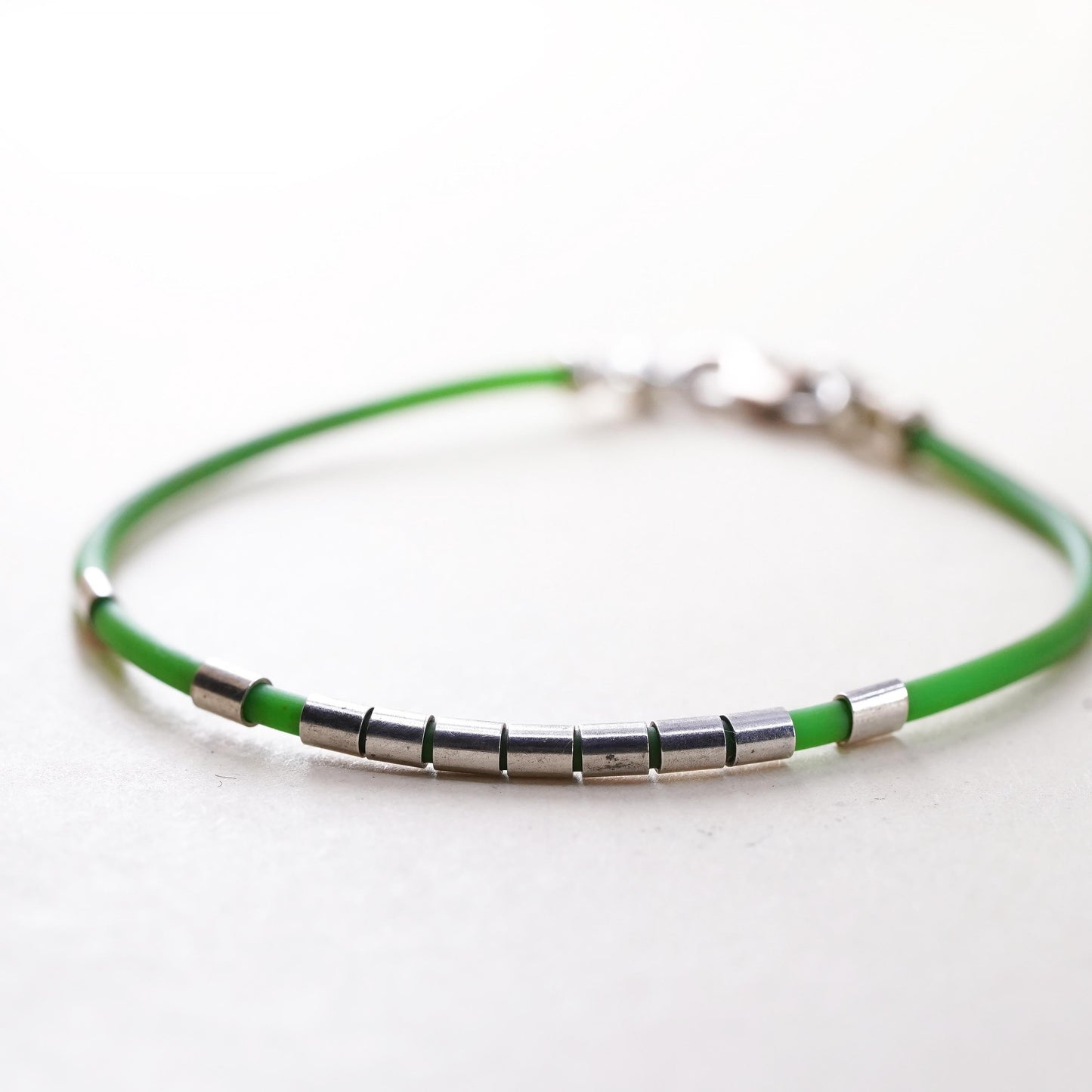 6”, Vintage green rubber band stackable bracelet with silver tone details