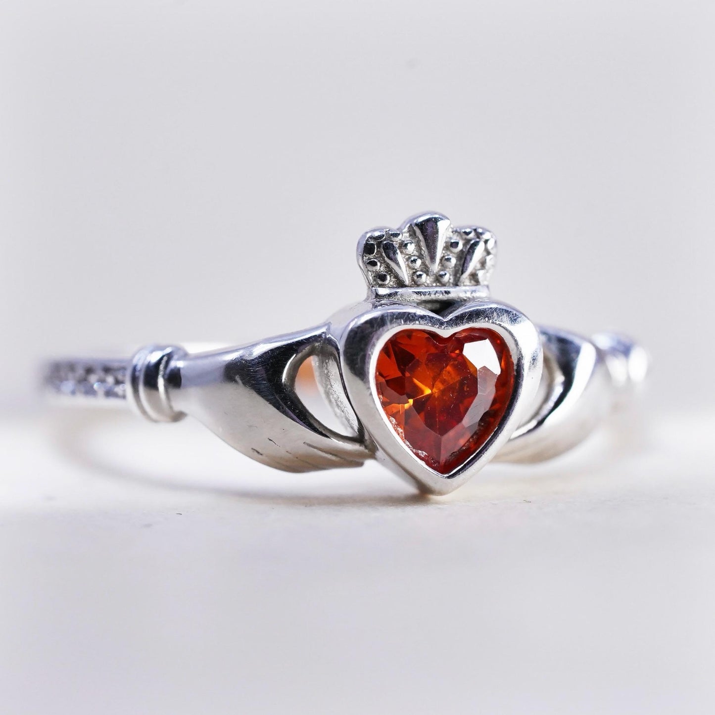 Size 8, Irish sterling 925 silver claddagh ring, holding heart, orange crystal