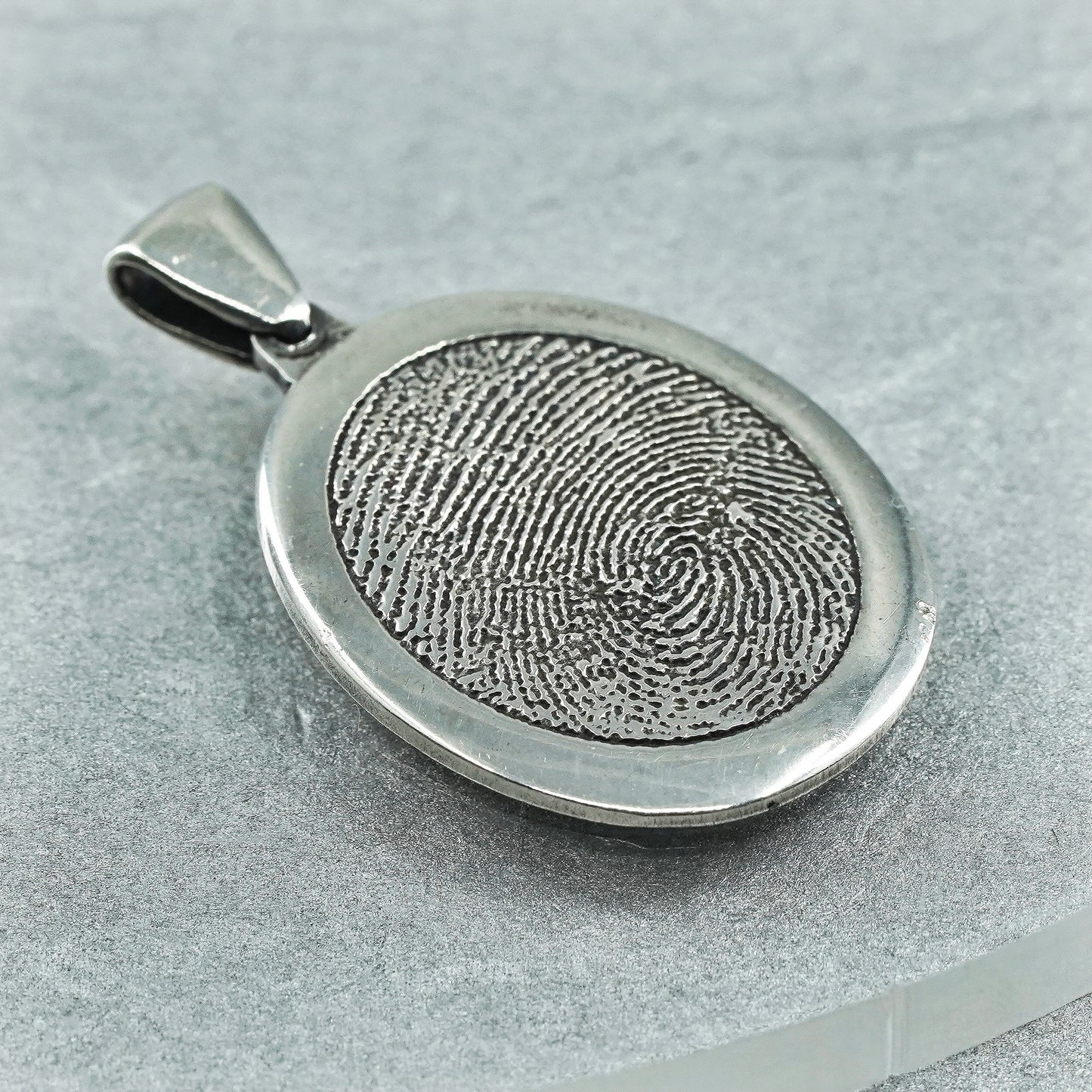 vintage sterling 925 silver pendant with oval fingerprint embossed “1977-2011”