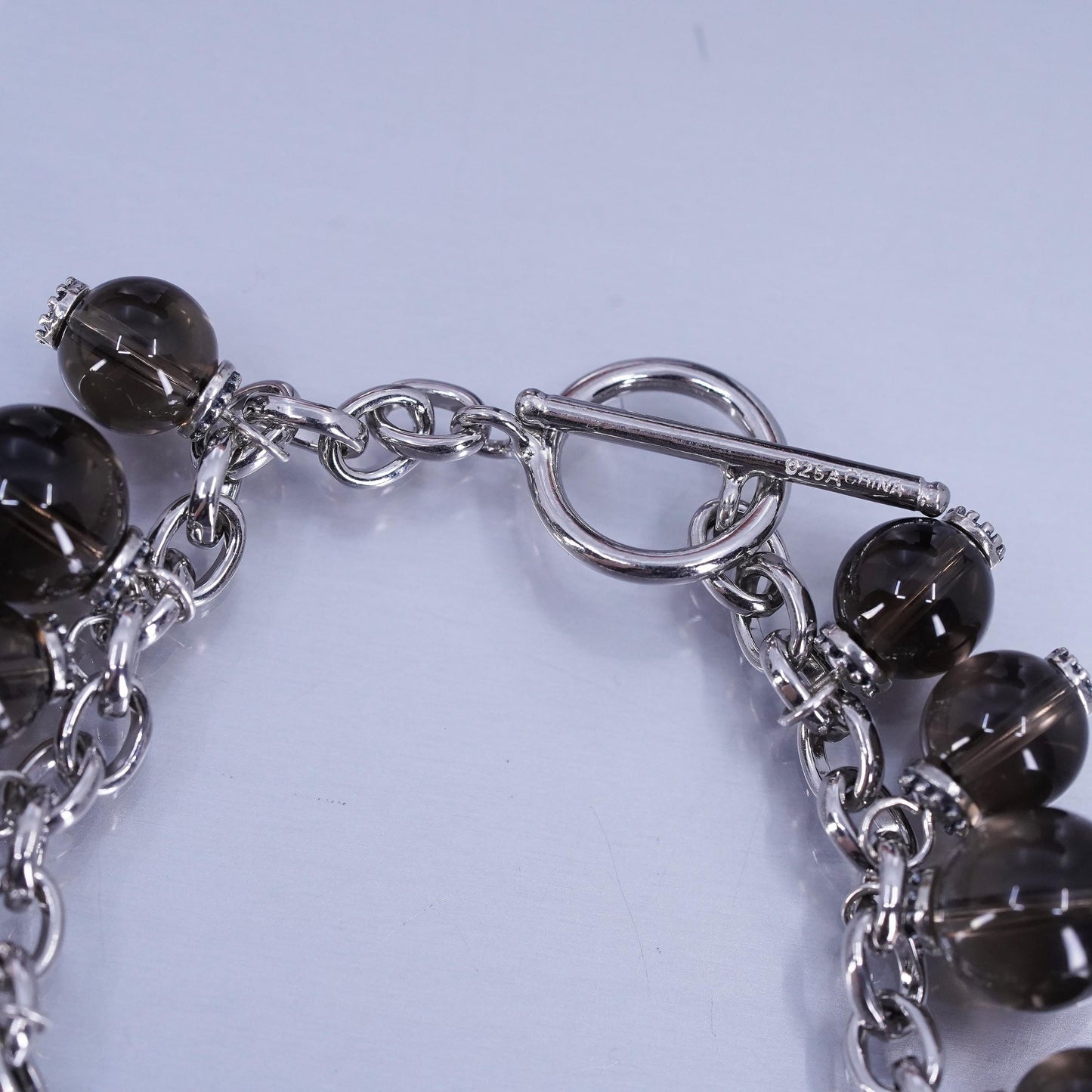 6.75”, Sterling 925 silver bracelet with smoky crystal beads and toggle closure