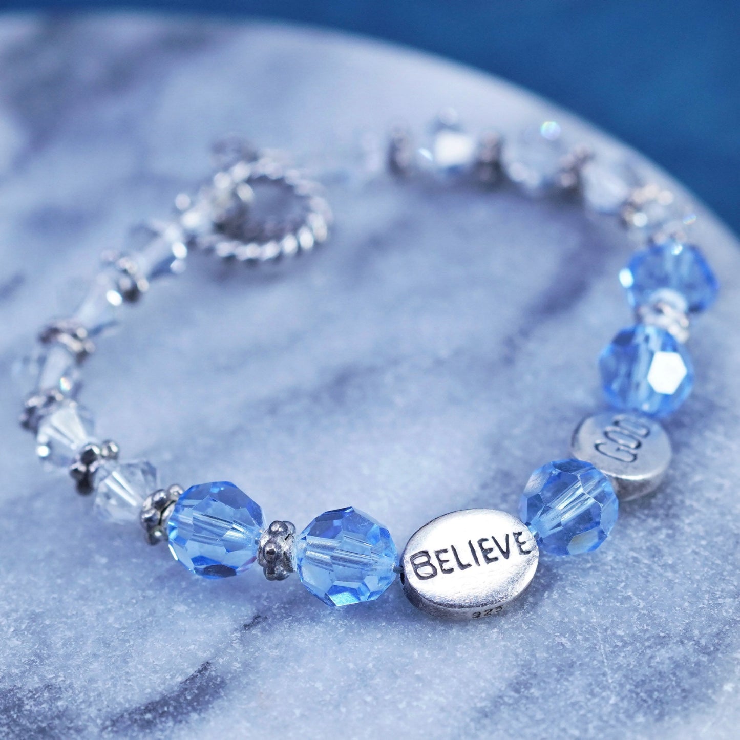 6.75”, Sterling 925 silver bracelet with blue crystal and believe god charms