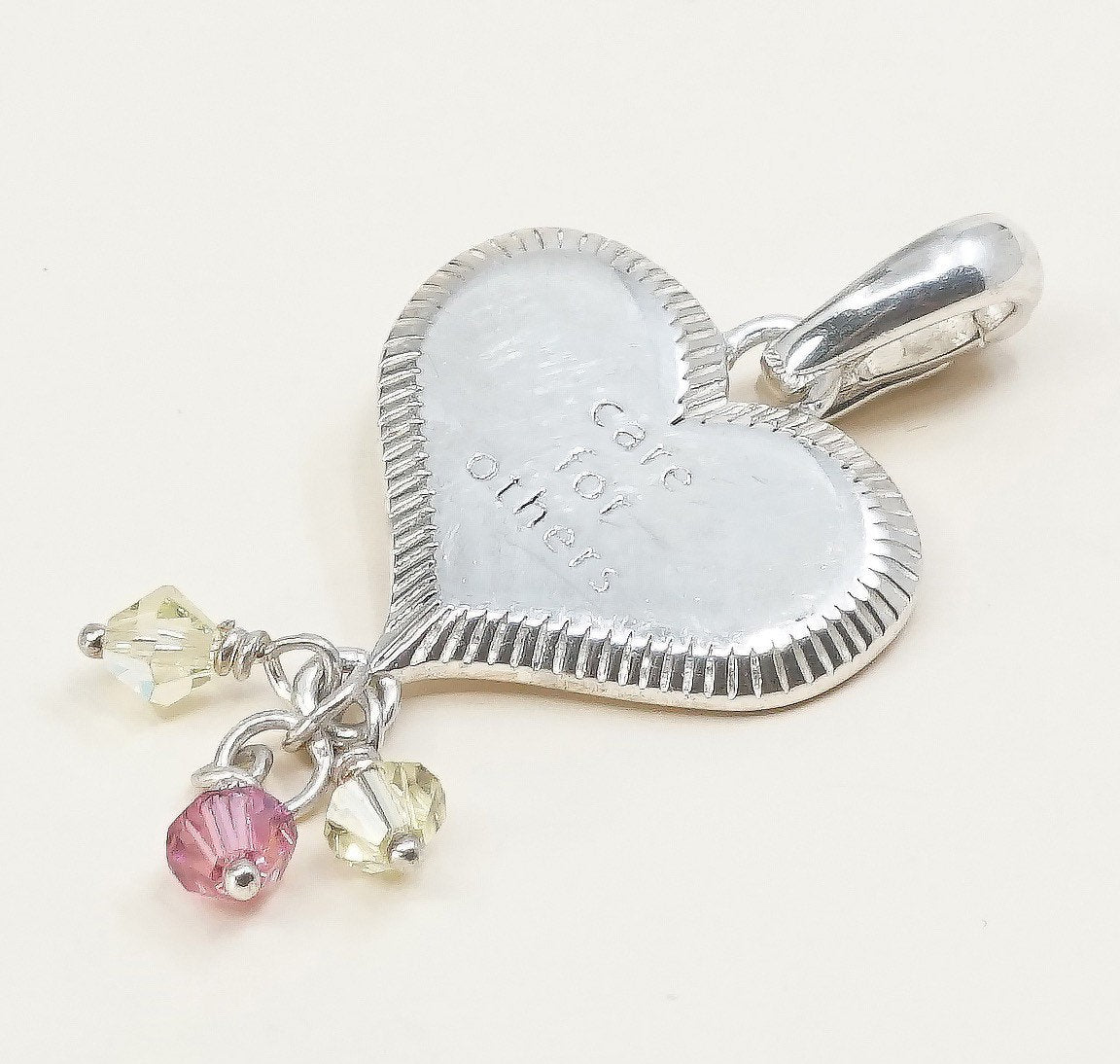 handmade sterling silver heart charm embossed “care for others”, 925 pendant