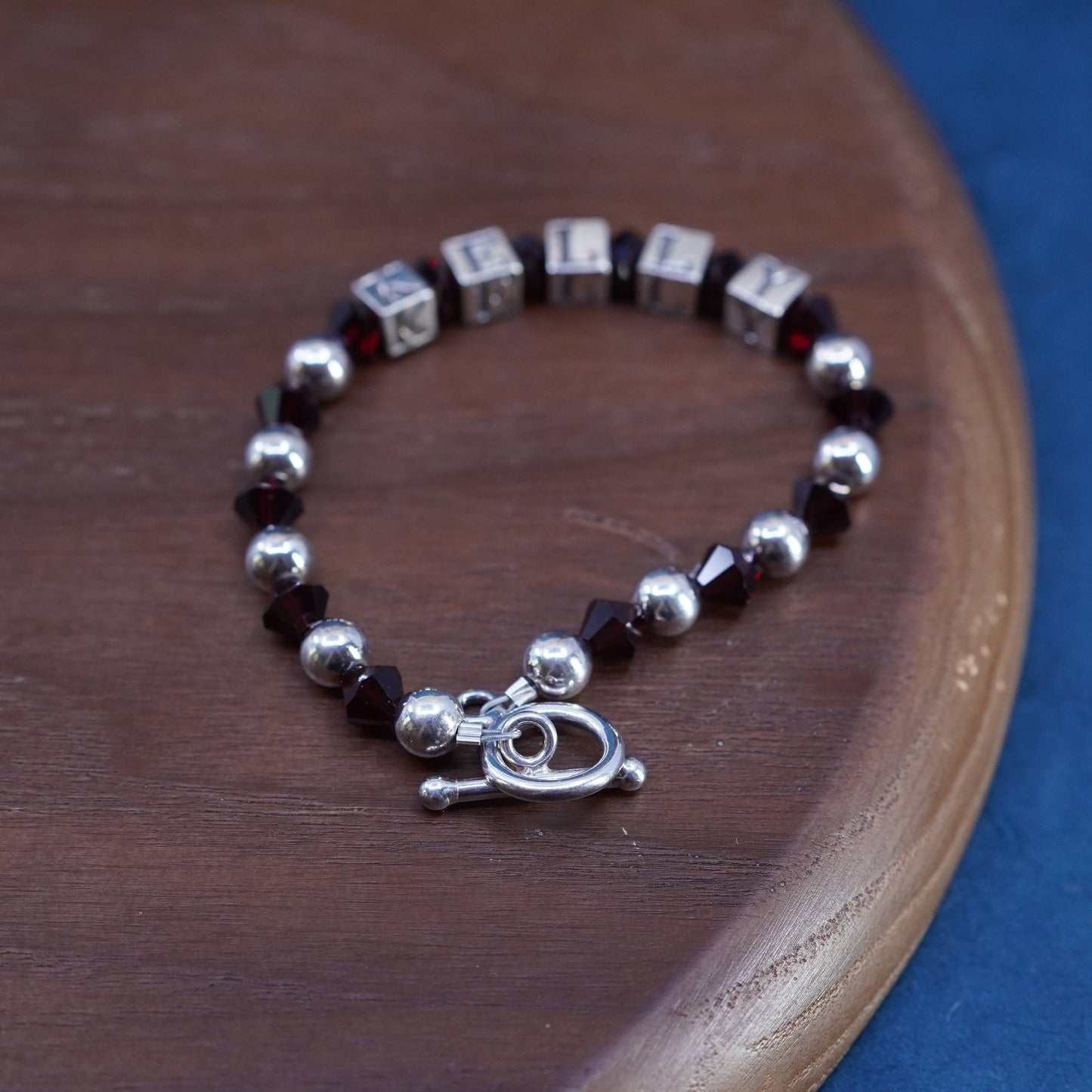 6.25”, sterling silver 925 bracelet with garnet beads and name “Kelly” cubes