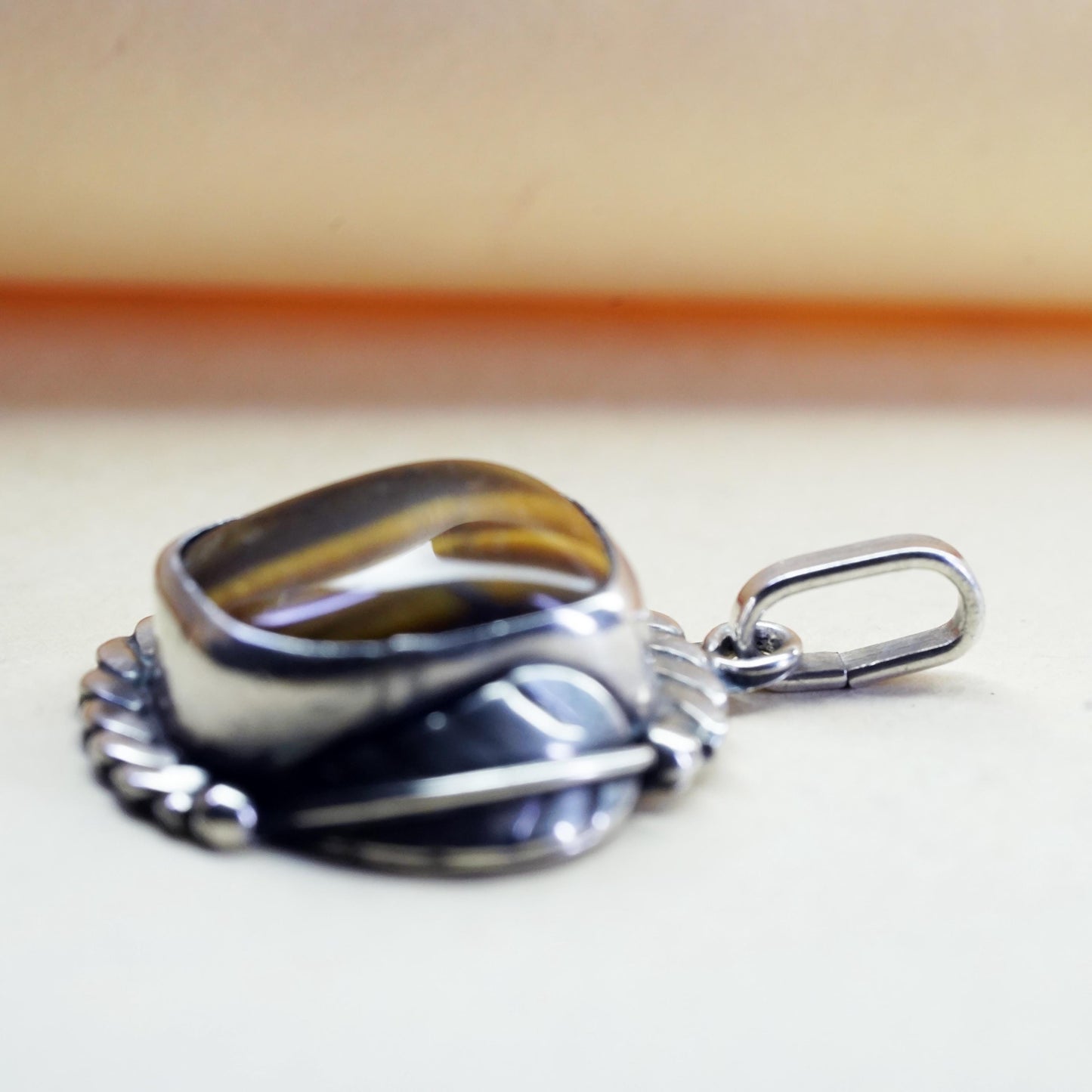 Vintage southwestern sterling 925 silver pendant with golden tiger eye feather