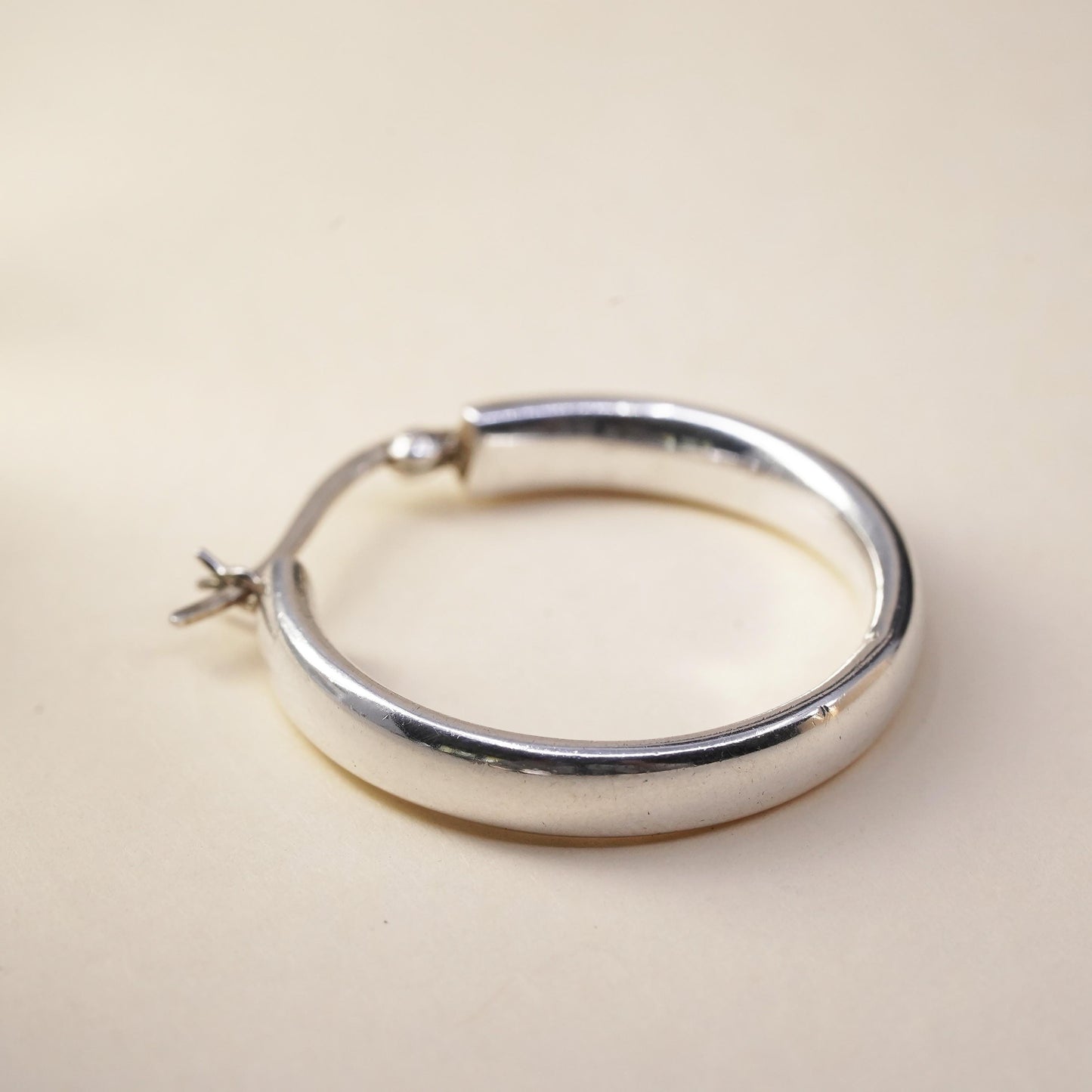 1.25” sterling silver loop single earring, textured minimalist primitive hoop