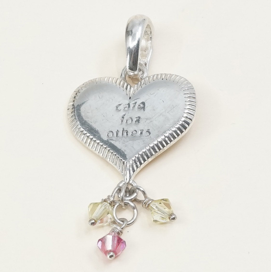 handmade sterling silver heart charm embossed “care for others”, 925 pendant