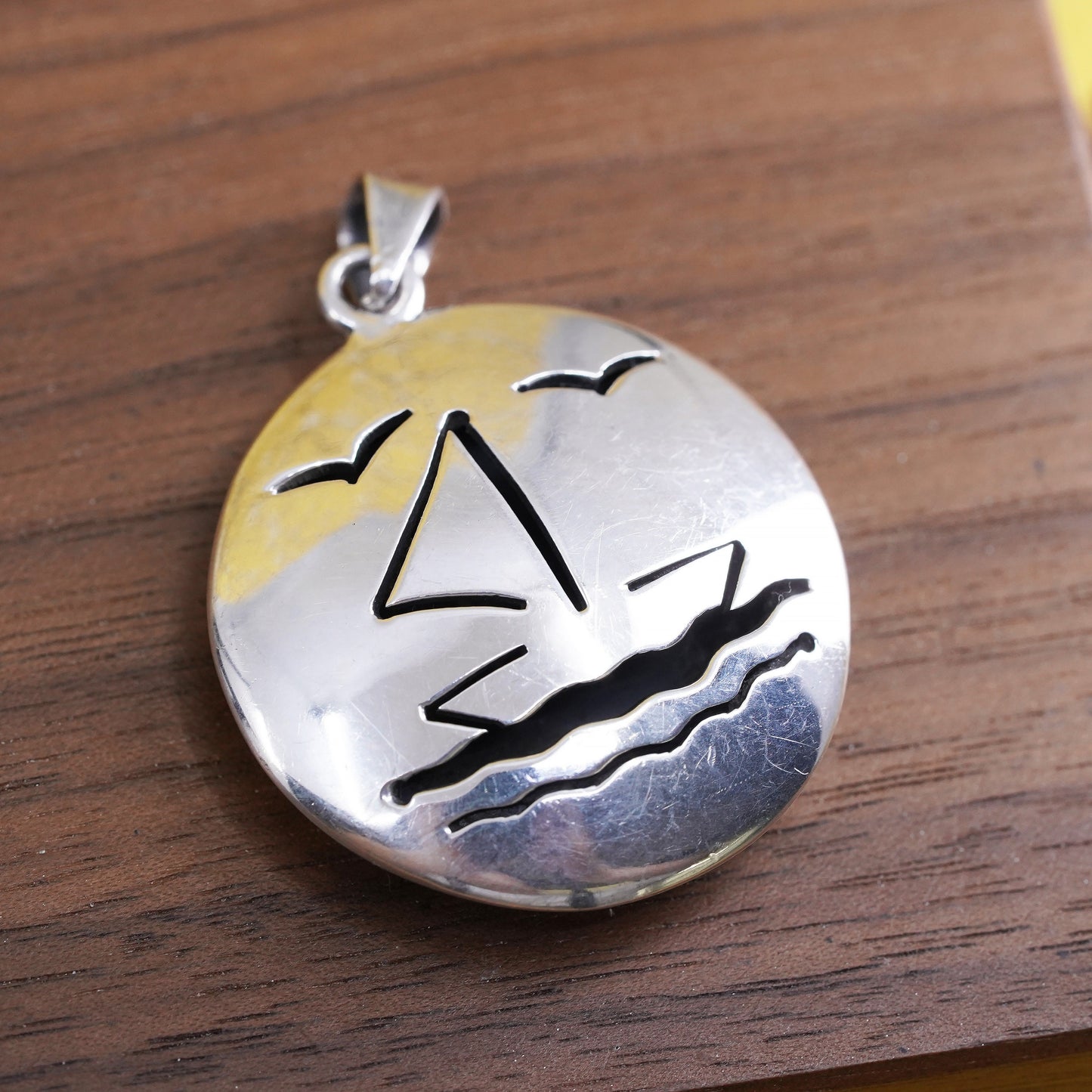 Sterling silver handmade pendant, puffy 925 circle with sailing boat cut out