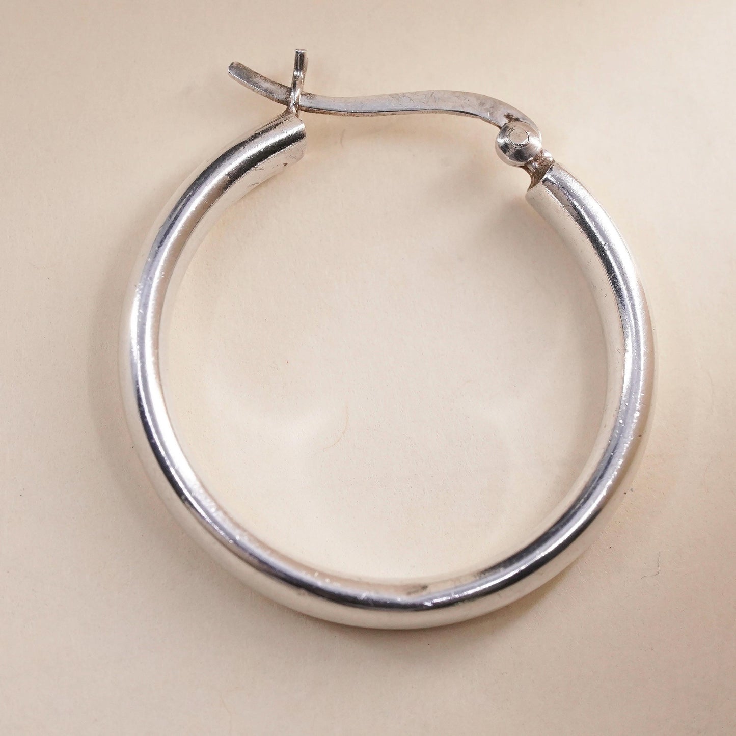 1.25” sterling silver loop single earring, textured minimalist primitive hoop