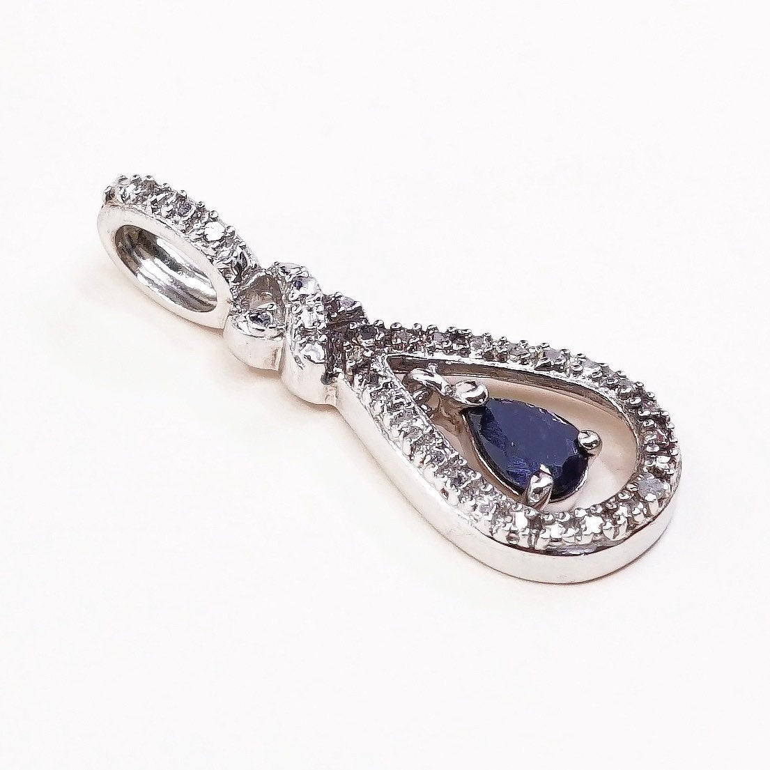 Sterling silver pendant with teardrop shaped sapphire, crystal around