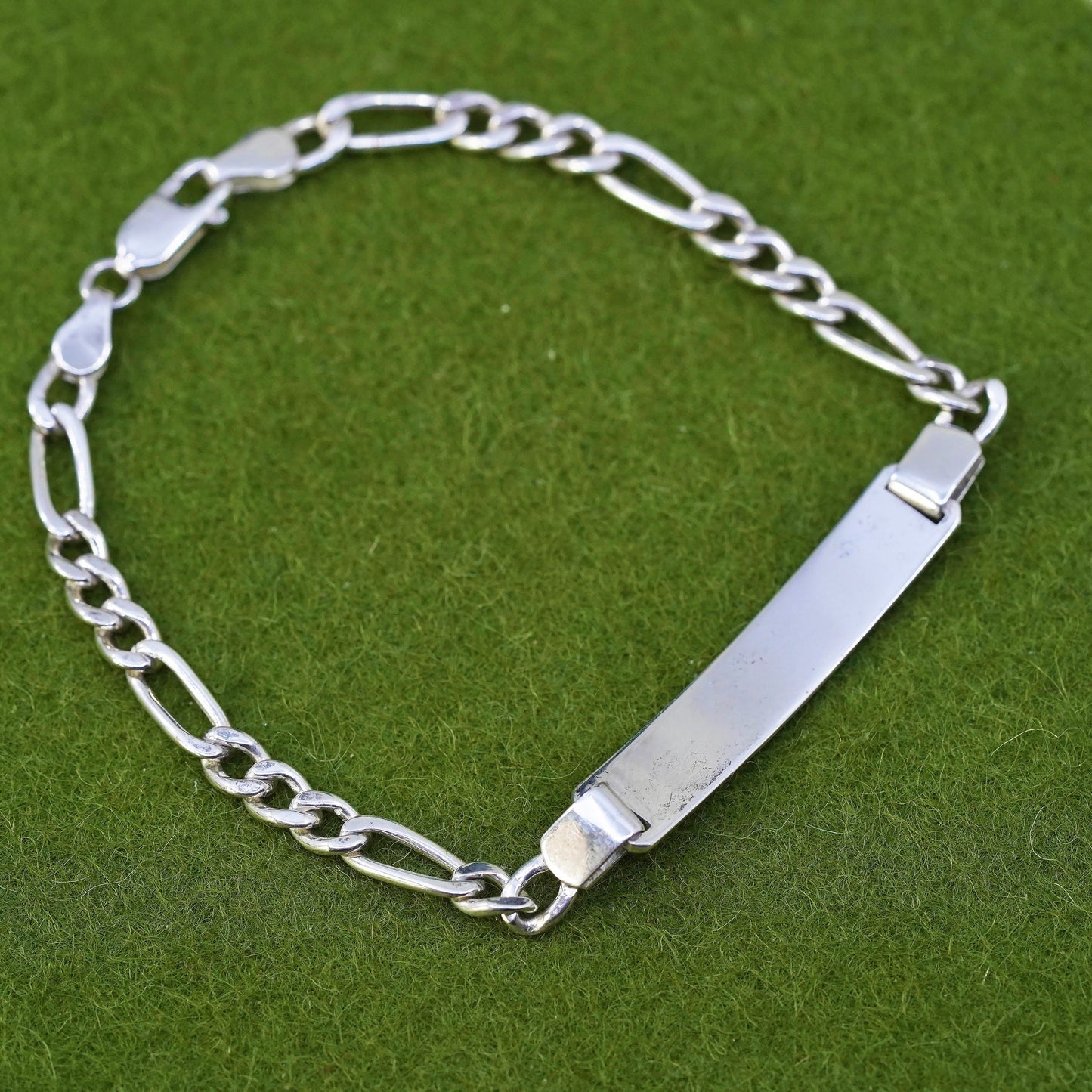 7.25” sterling silver bracelet, 925 figaro chain with line engraved bar tag