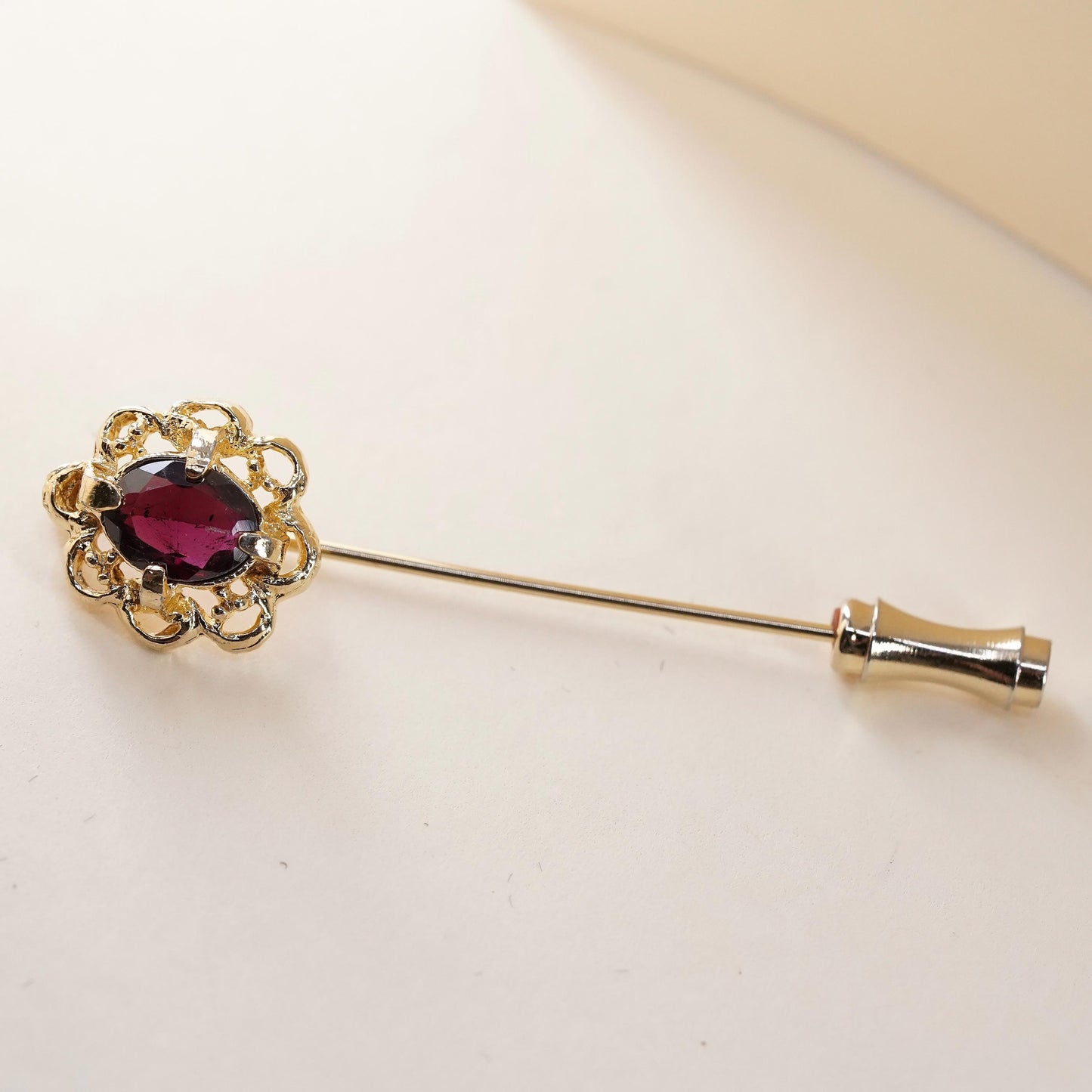 Vintage gold tone pin with garnet