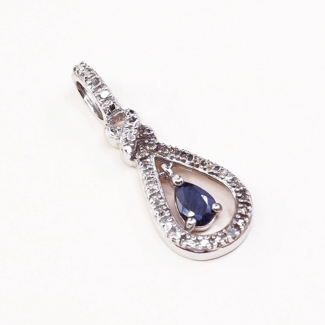 Sterling silver pendant with teardrop shaped sapphire, crystal around