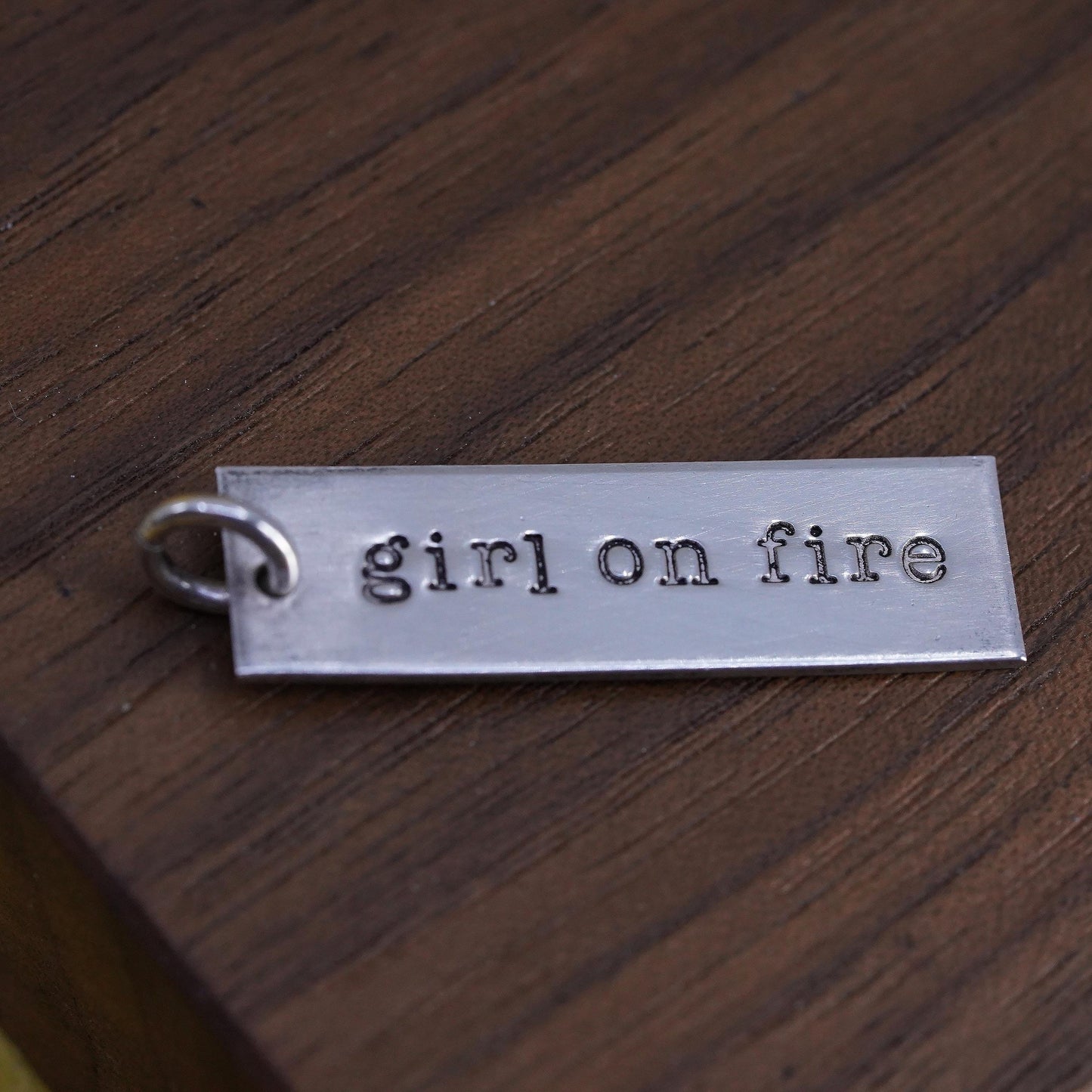 Sterling silver charm, 925 tag pendant embossed “girl on fire”