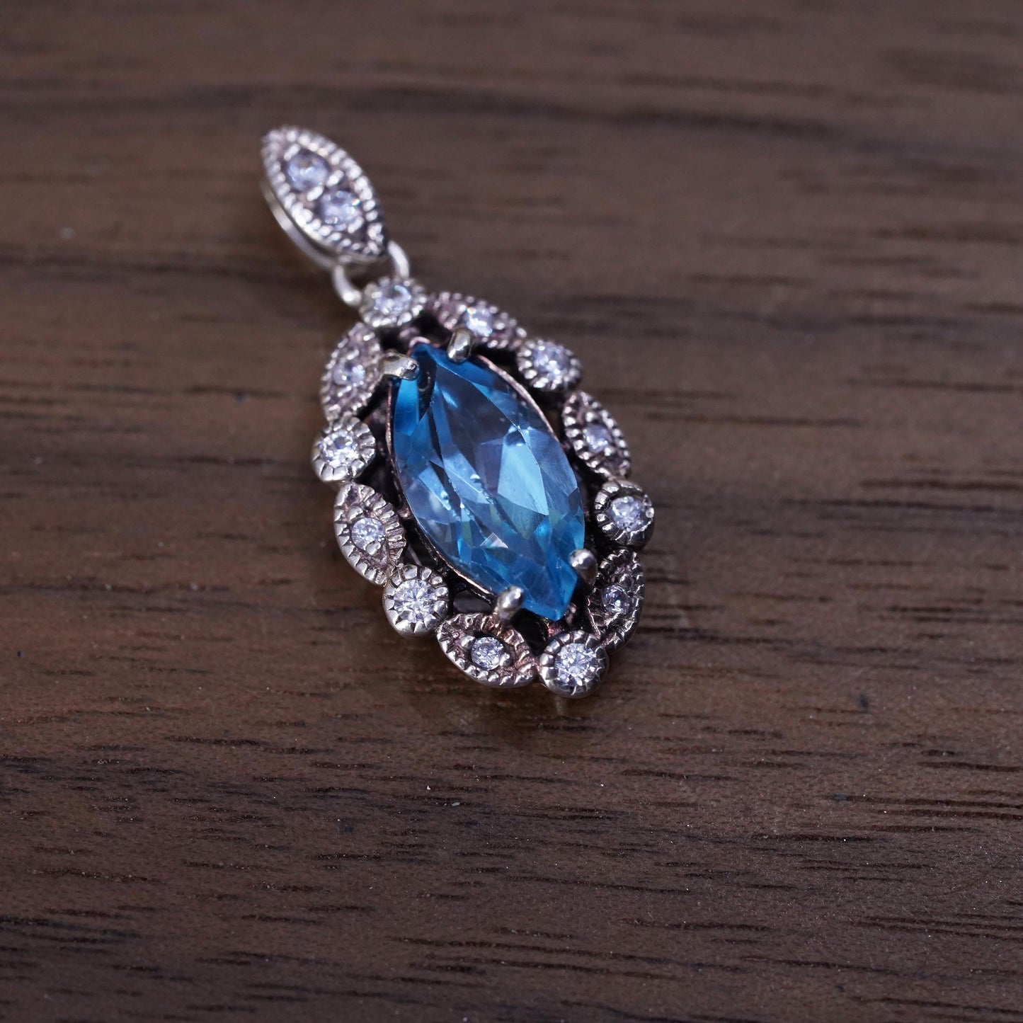 Vintage Sterling 925 silver handmade pendant with blue topaz and cz around