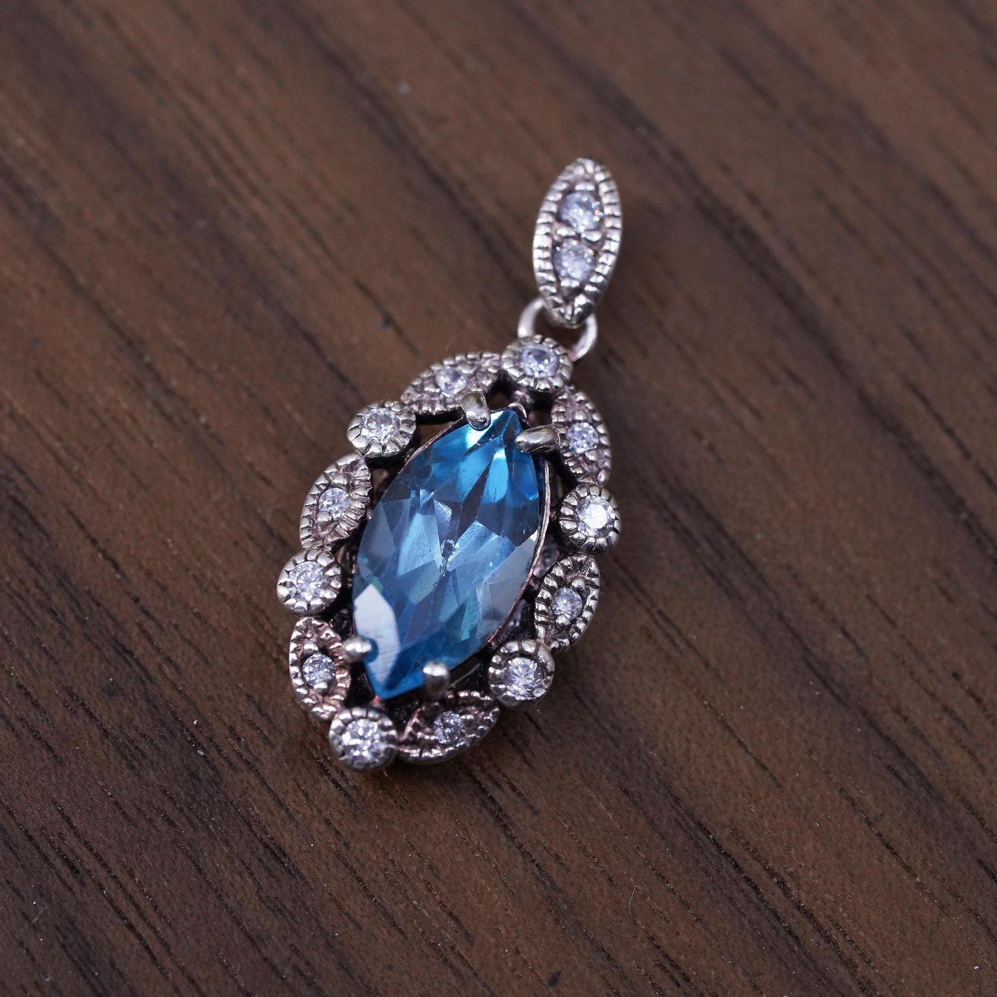 Vintage Sterling 925 silver handmade pendant with blue topaz and cz around