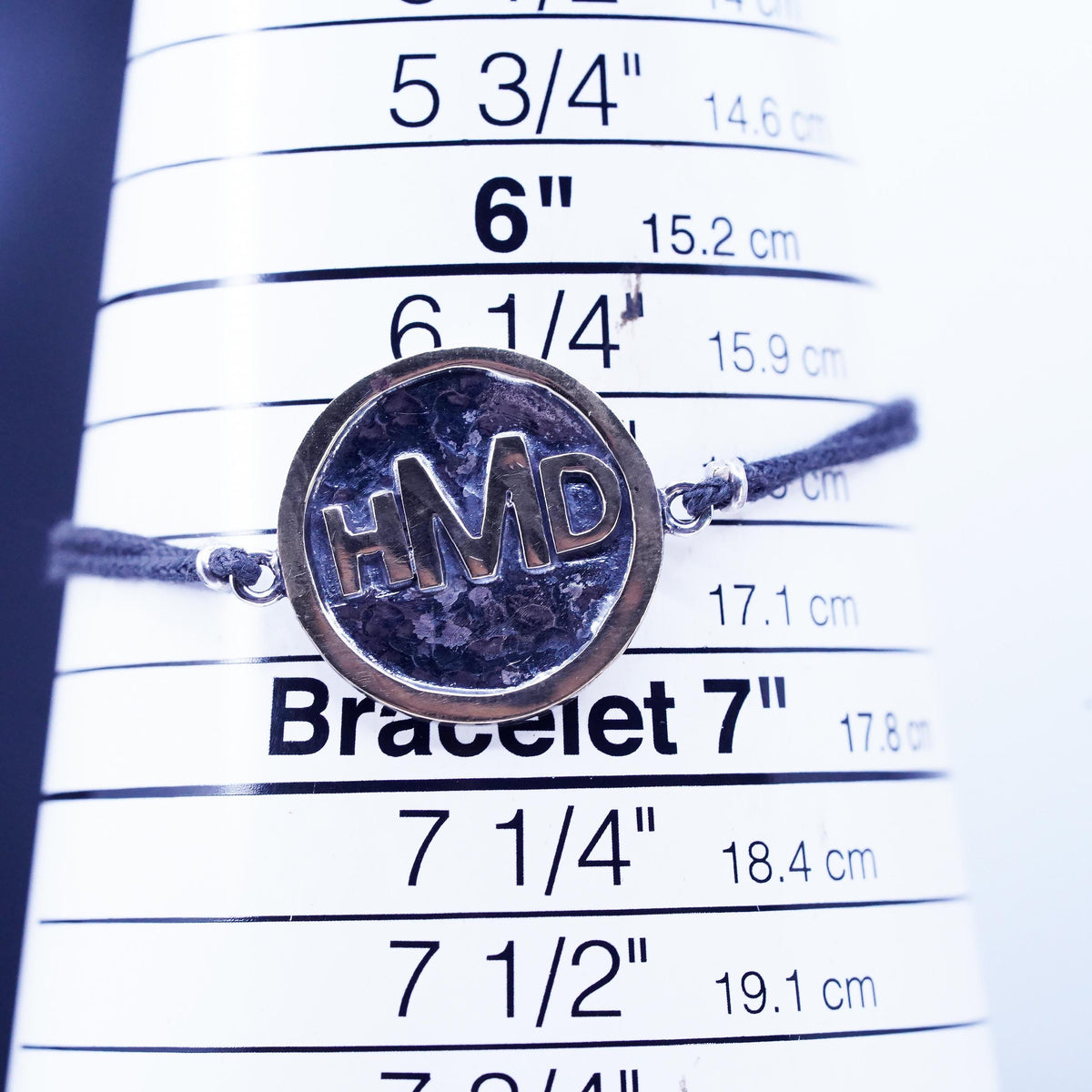 6.75", Signed two tone sterling 925 silver monogram "HDM" tag black bracelet
