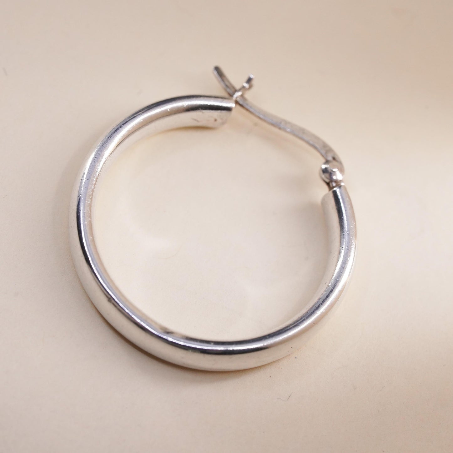 1.25” sterling silver loop single earring, textured minimalist primitive hoop