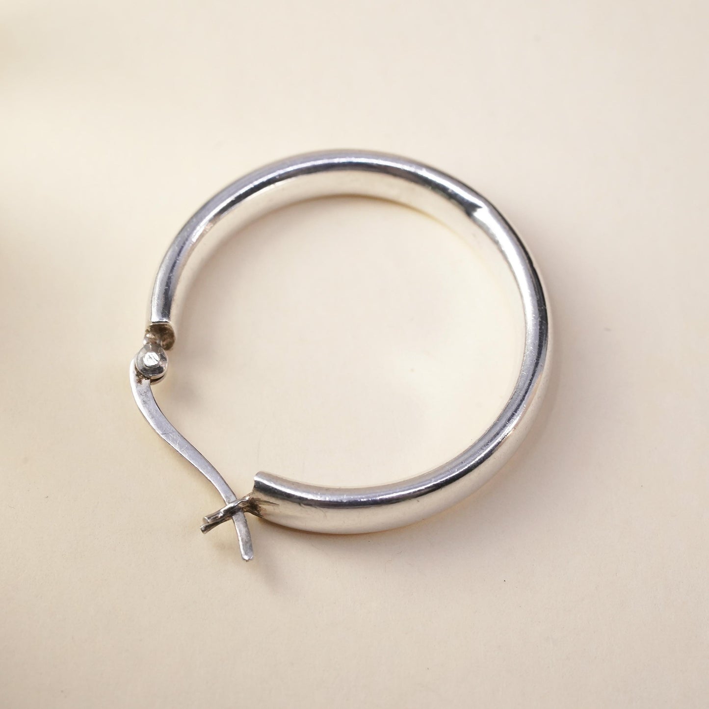 1.25” sterling silver loop single earring, textured minimalist primitive hoop