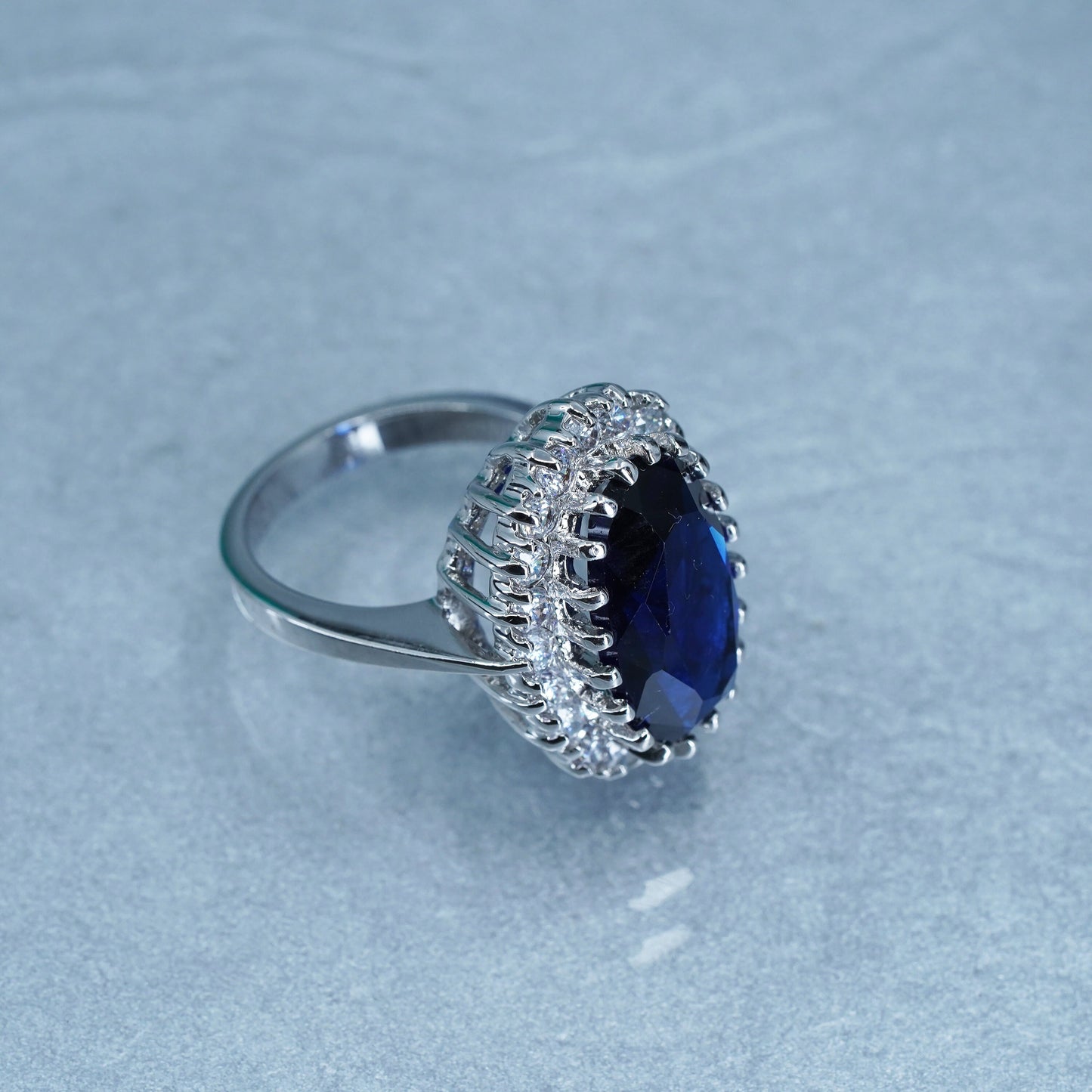 Size 8.25, vintage silver tone statement ring with blue glass and cz around