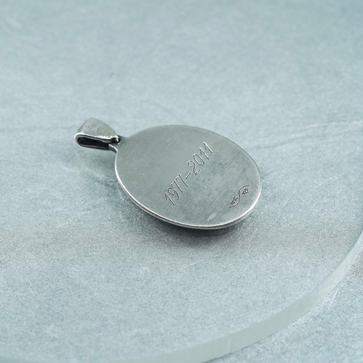 vintage sterling 925 silver pendant with oval fingerprint embossed “1977-2011”