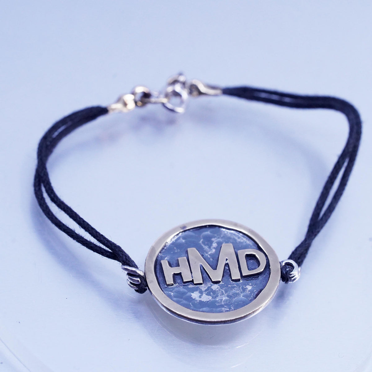 6.75", Signed two tone sterling 925 silver monogram "HDM" tag black bracelet