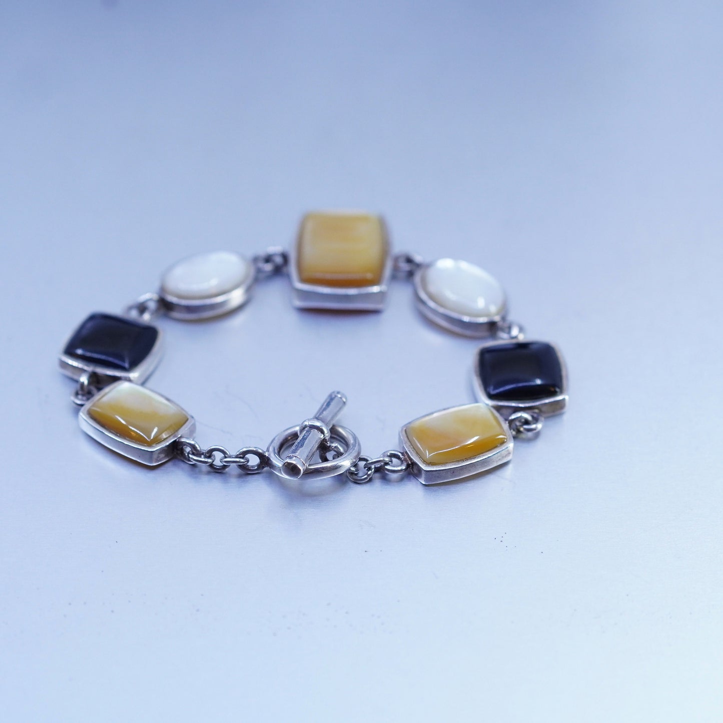 6.75”, VTG sterling 925 silver bracelet w/ black onyx golden mother of pearl