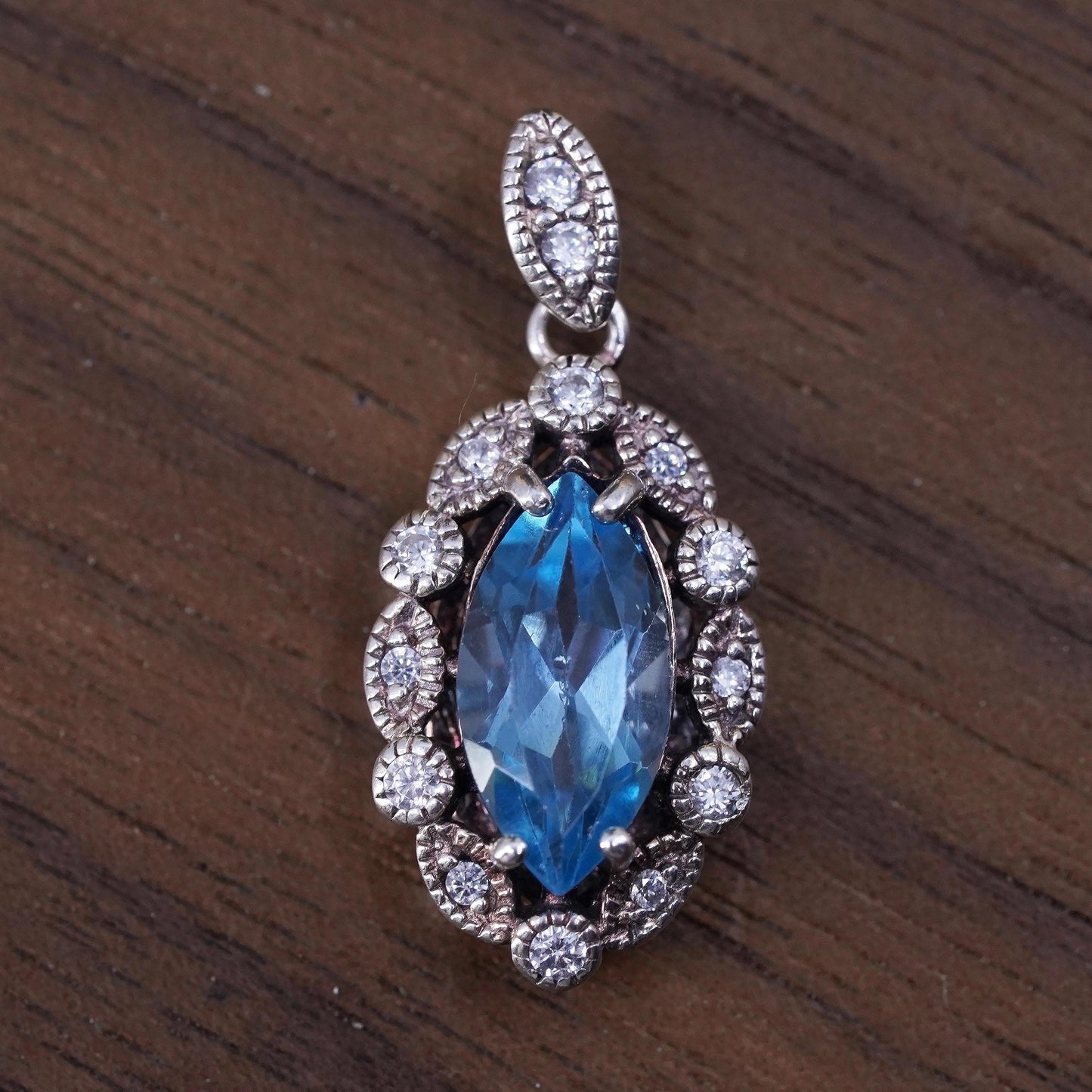 Vintage Sterling 925 silver handmade pendant with blue topaz and cz around