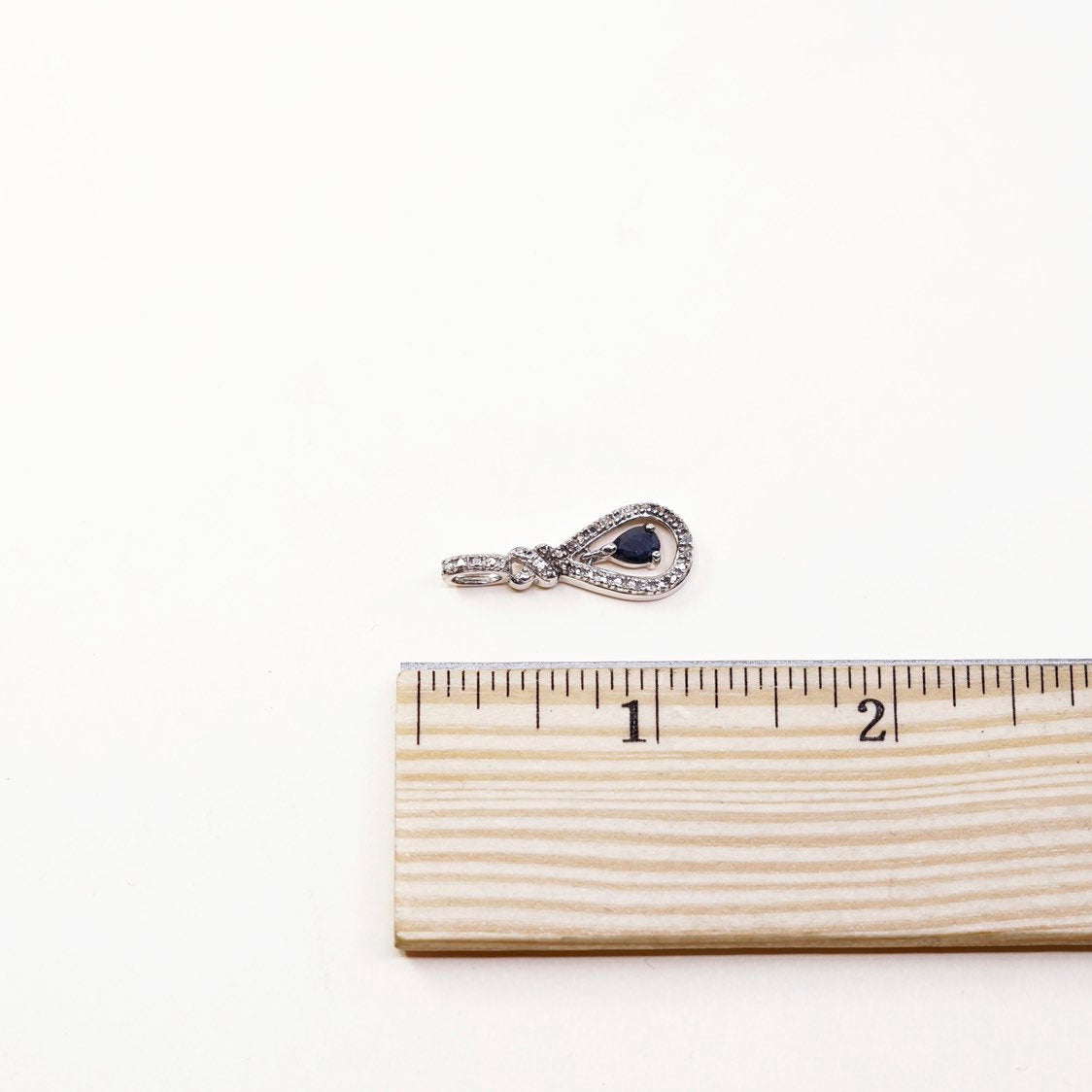 Sterling silver pendant with teardrop shaped sapphire, crystal around