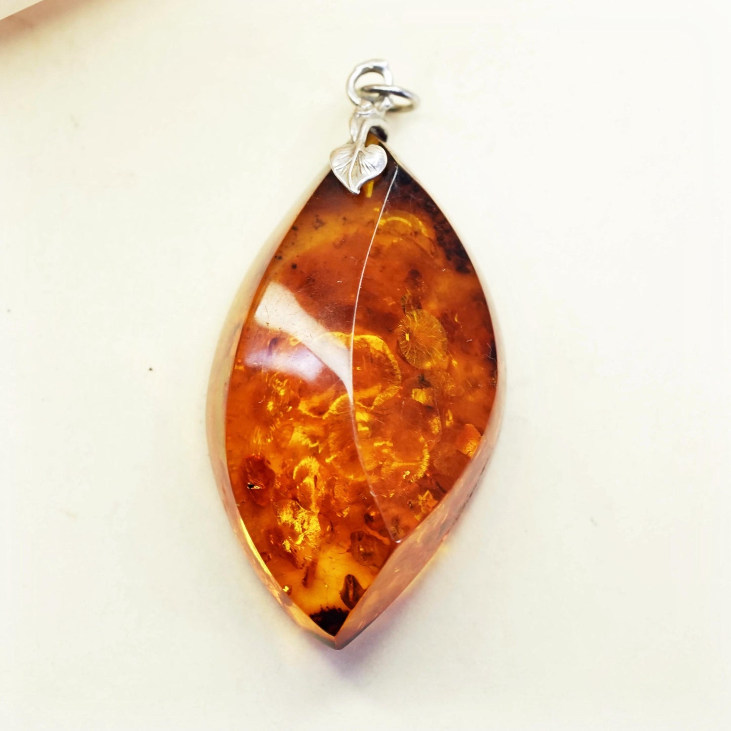 Vintage sterling 925 silver handmade pendant with amber nugget and leaf bail