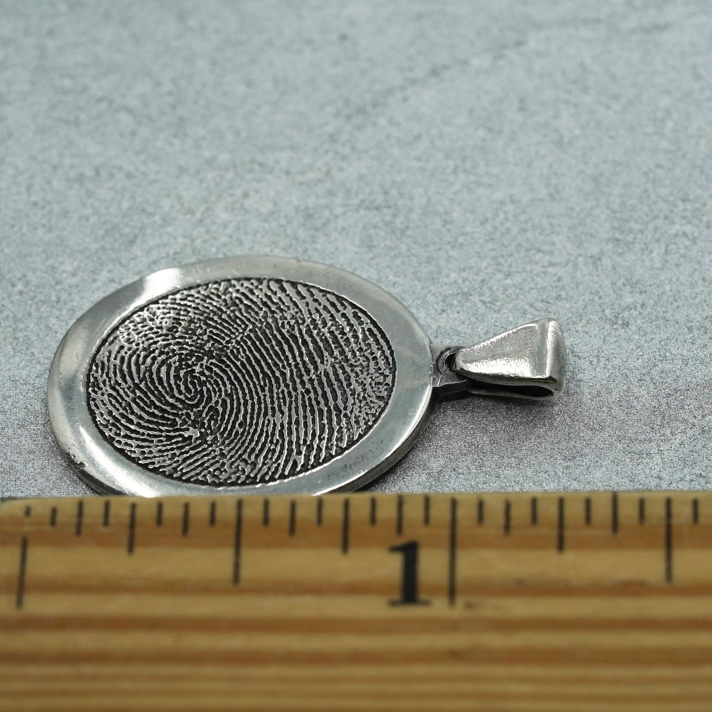 vintage sterling 925 silver pendant with oval fingerprint embossed “1977-2011”