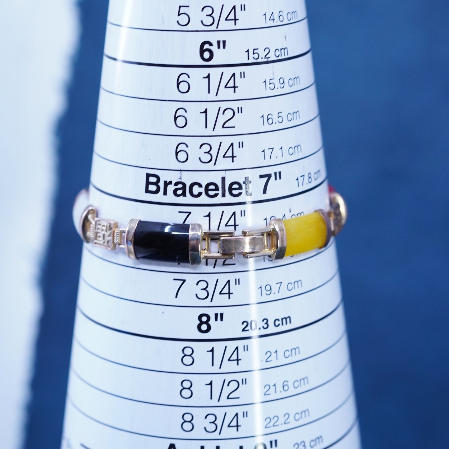 7.5”, yellow tone tennis bracelet with jade, carnelian, obsidian bar happiness