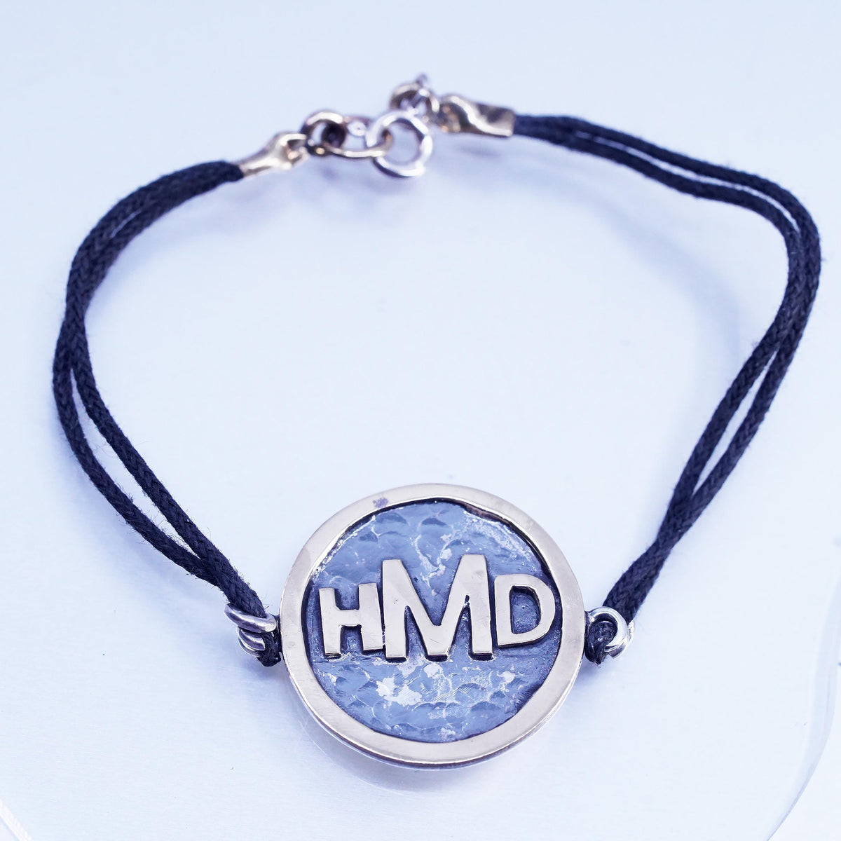 6.75", Signed two tone sterling 925 silver monogram "HDM" tag black bracelet