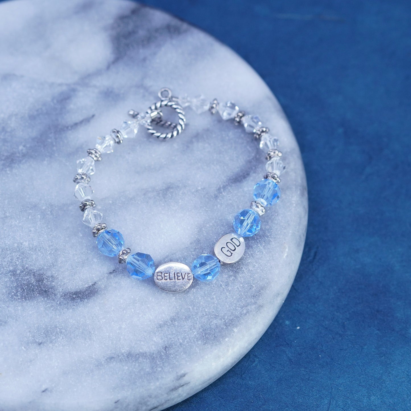 6.75”, Sterling 925 silver bracelet with blue crystal and believe god charms