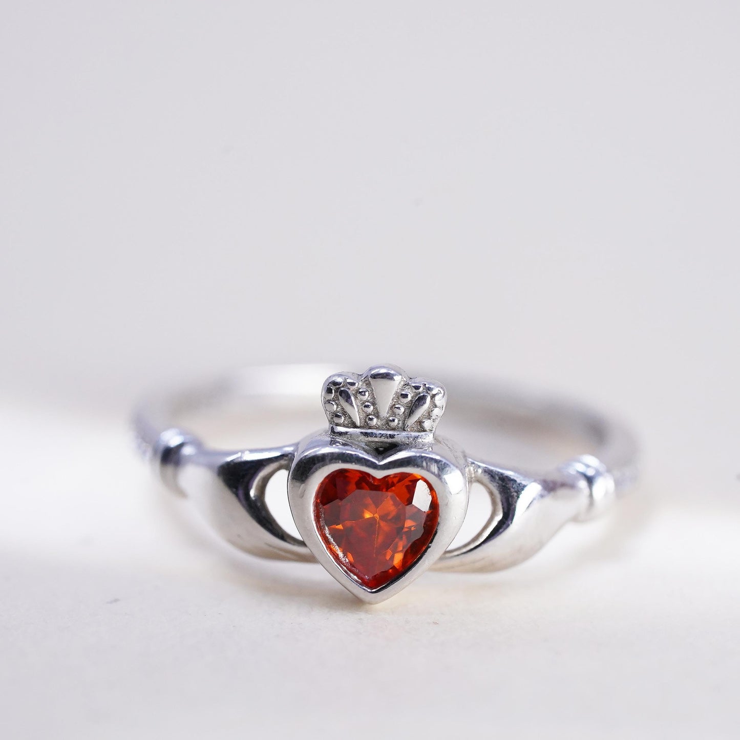 Size 8, Irish sterling 925 silver claddagh ring, holding heart, orange crystal