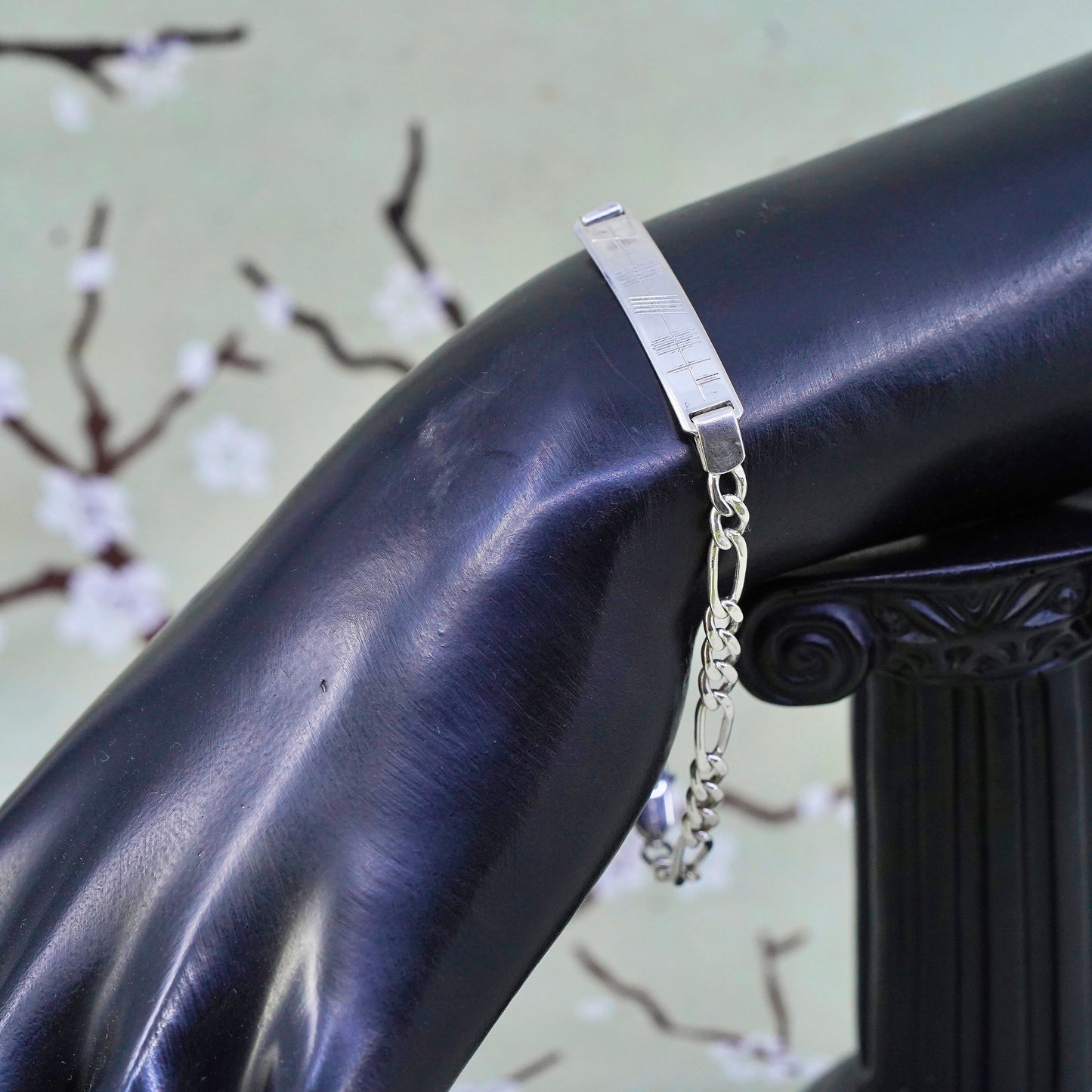 7.25” sterling silver bracelet, 925 figaro chain with line engraved bar tag