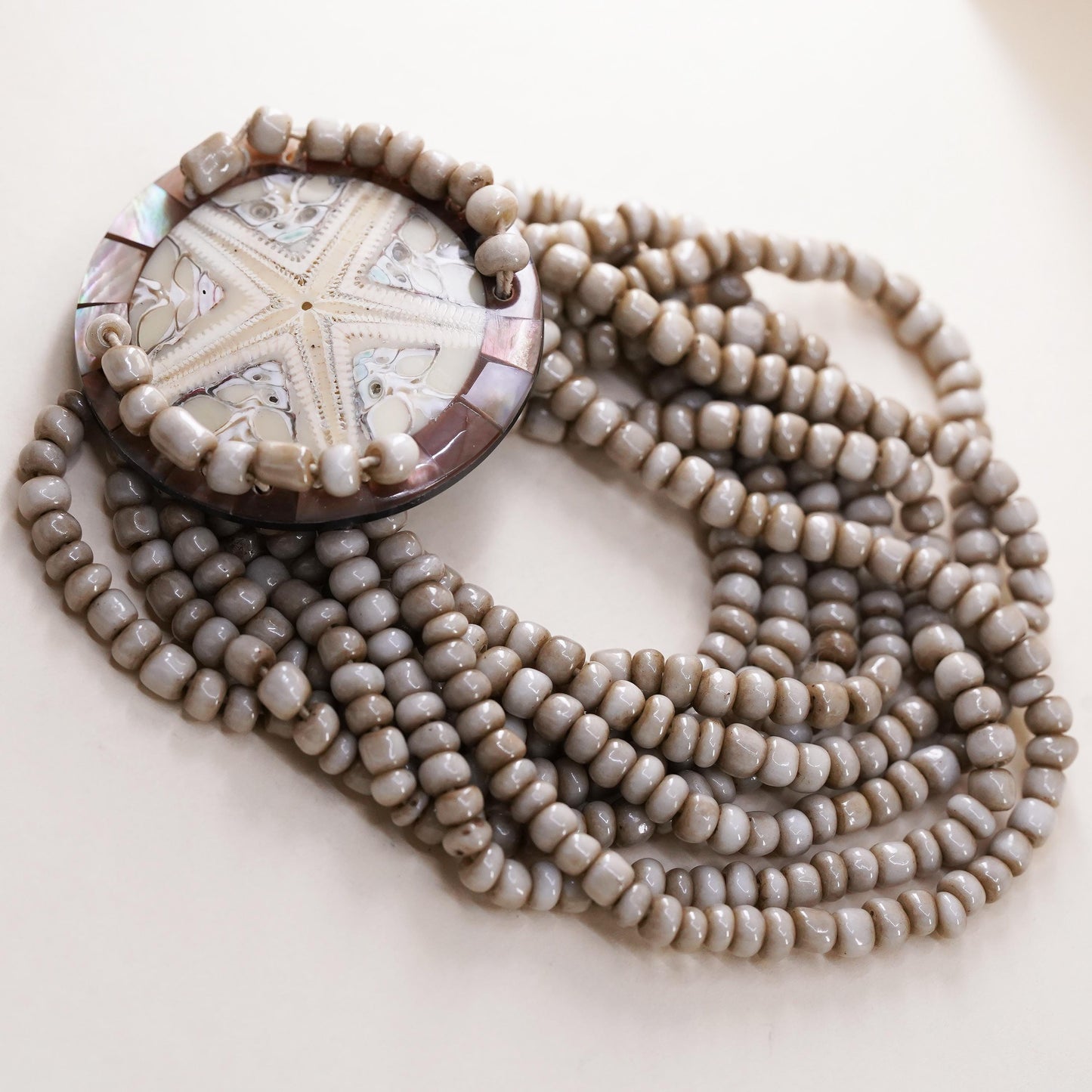 8", Vintage stretchy band, multi strands bead bracelet fossilized sand dollar