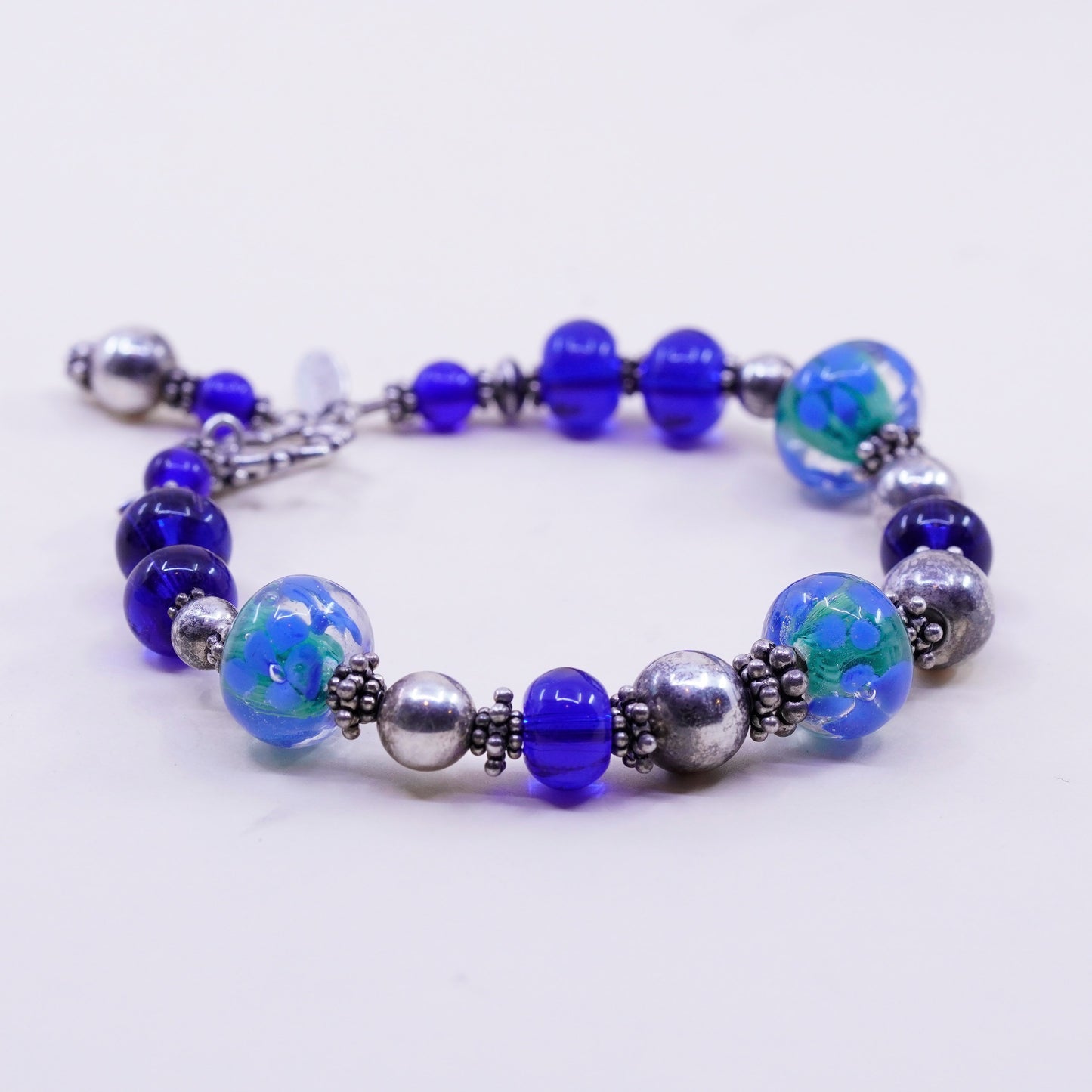 7.75”, vintage 925 Sterling silver bracelet with artisan blue glass beads