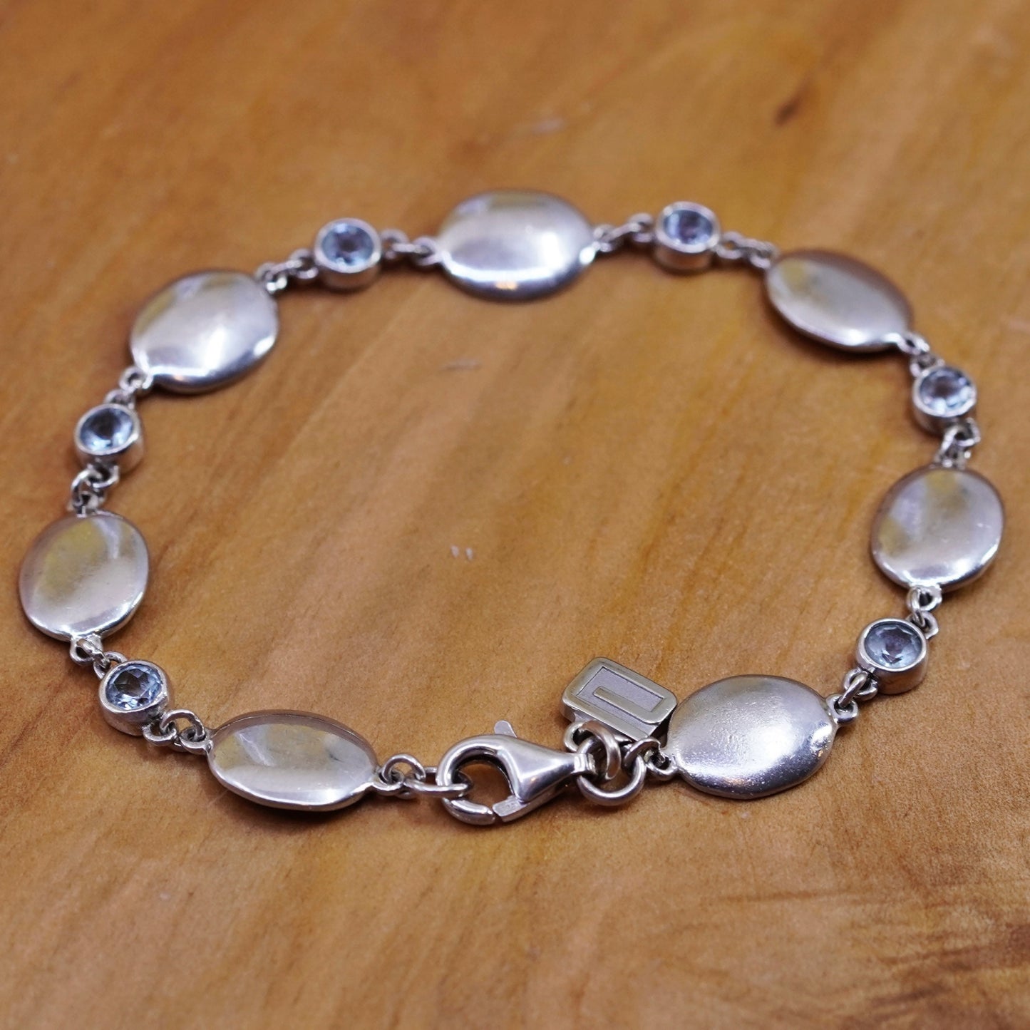 7.25”, Sterling silver bracelet, 925 oval chain with 10K gold charm and topaz