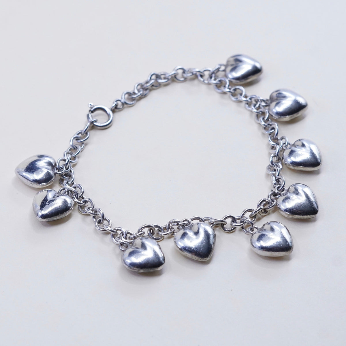 7.75”, 3mm, vtg JCM sterling 925 silver circle bracelet w/ cluster heart charms