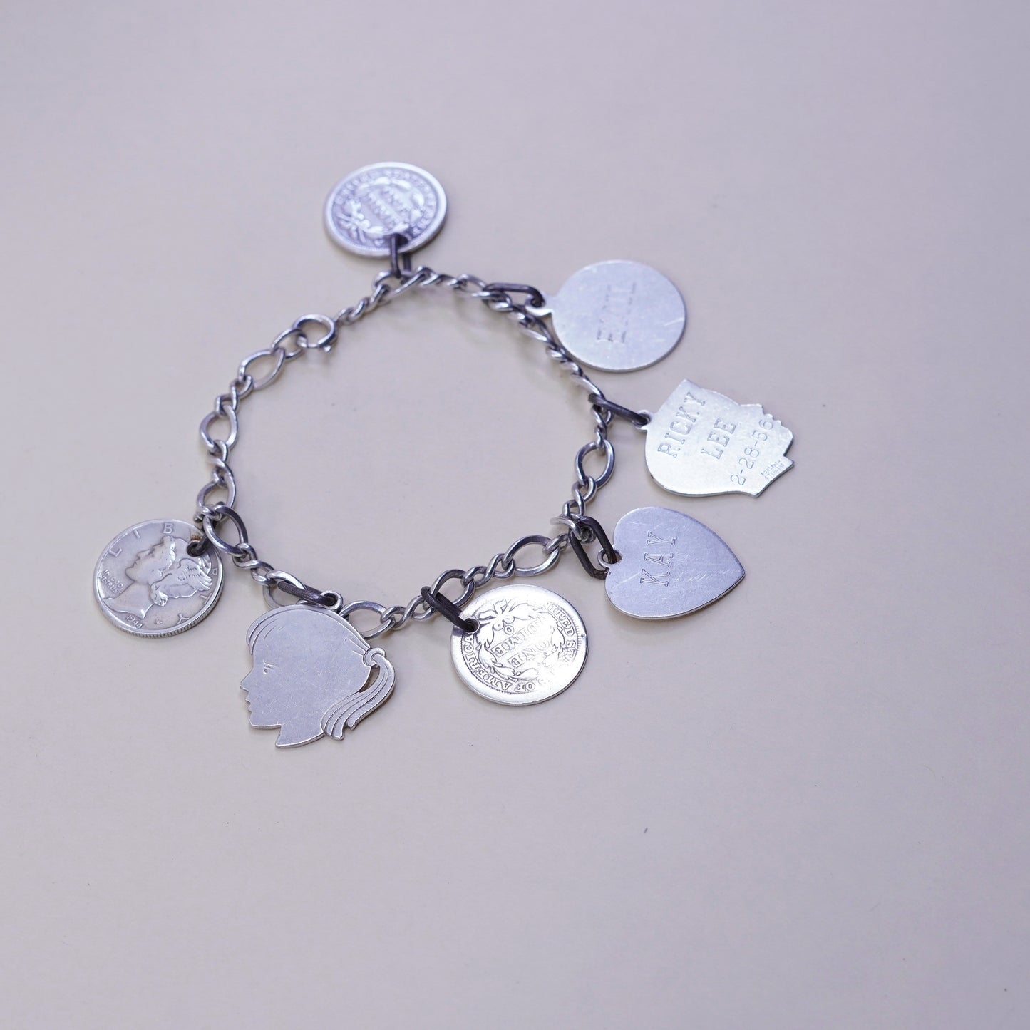 7”, sterling silver handmade bracelet, 925 Figaro chain w/ coin charms names