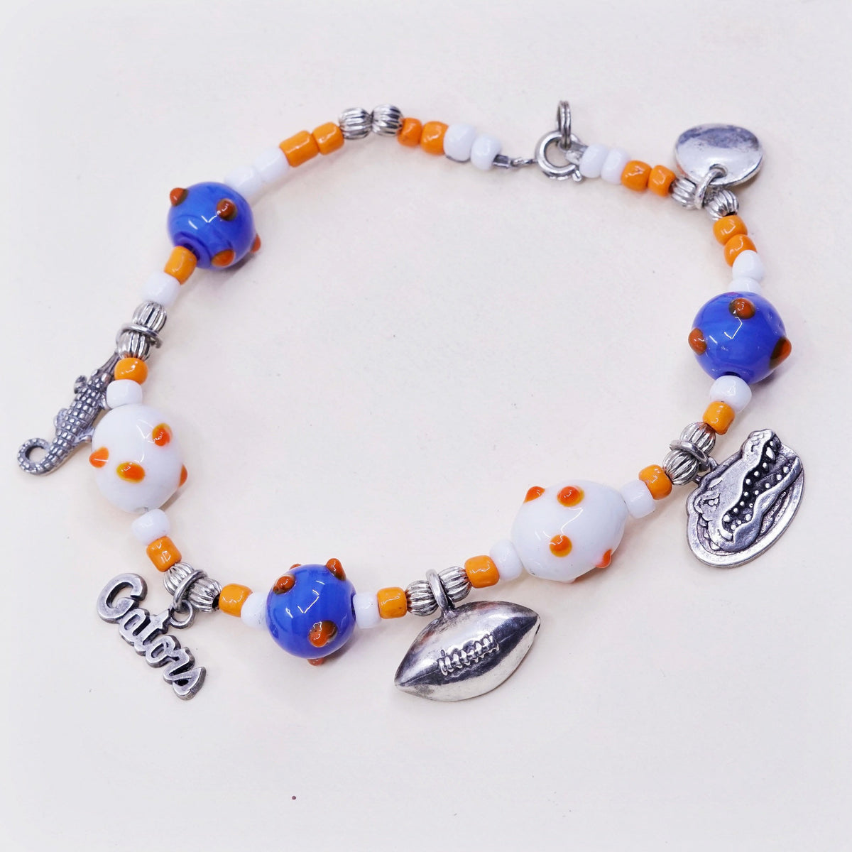 7.75”, blue and orange glass beads w/ sterling 925 silver alligator football