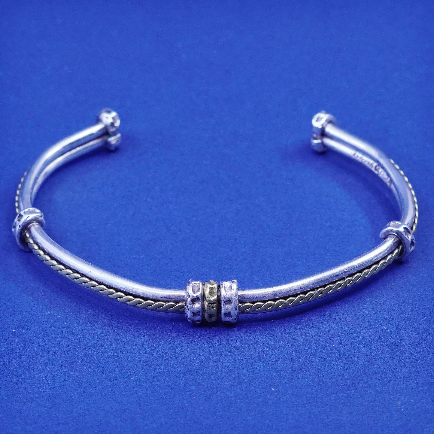 7.25”, two tone Sterling silver bracelet, ribbed 925 cuff with brass cable