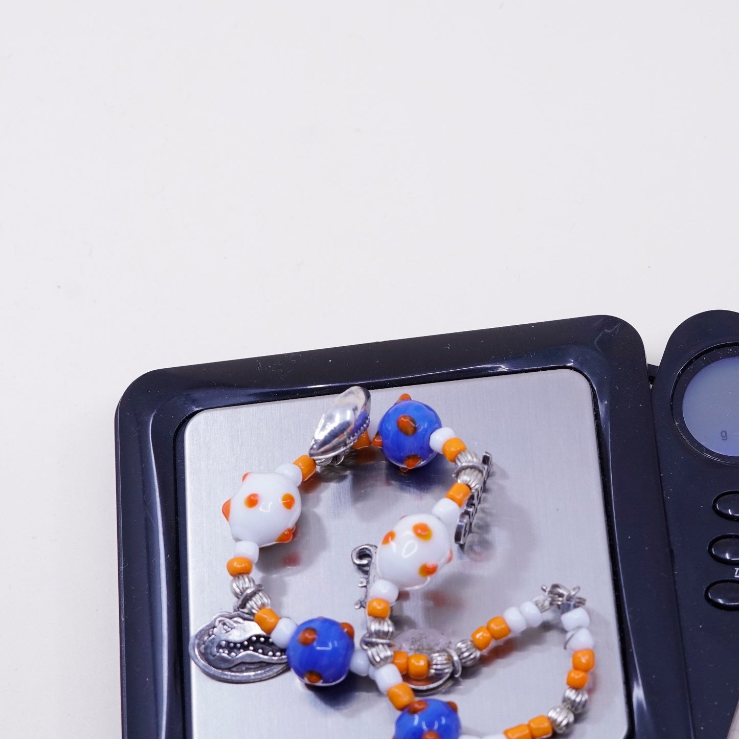 7.75”, blue and orange glass beads w/ sterling 925 silver alligator football